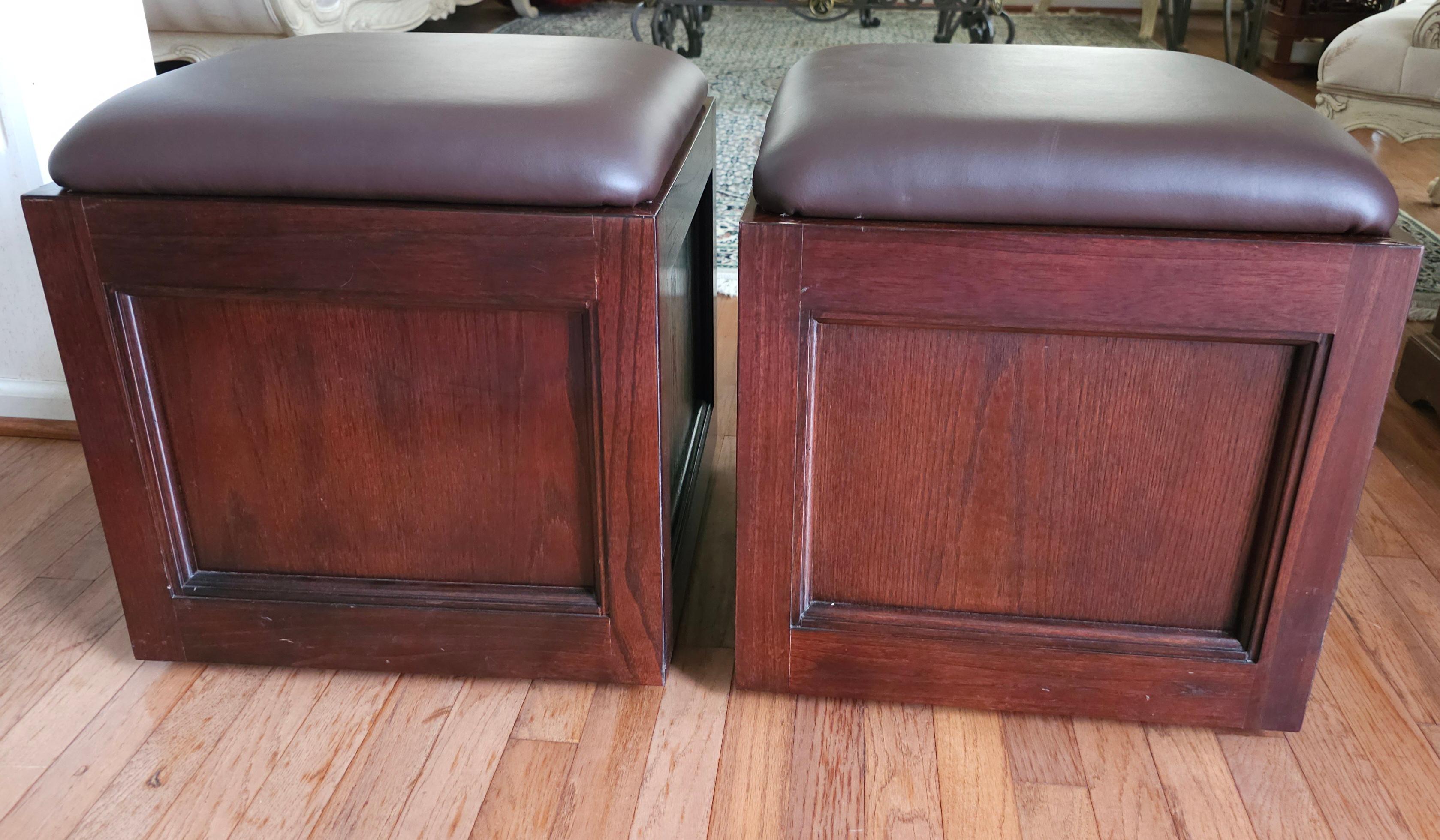 A Pair Of  Fruitwood And Brown Leather Rolling Storage Ottomans by Hammary Furniture of Lenoir, North Carolina.
Measures 18