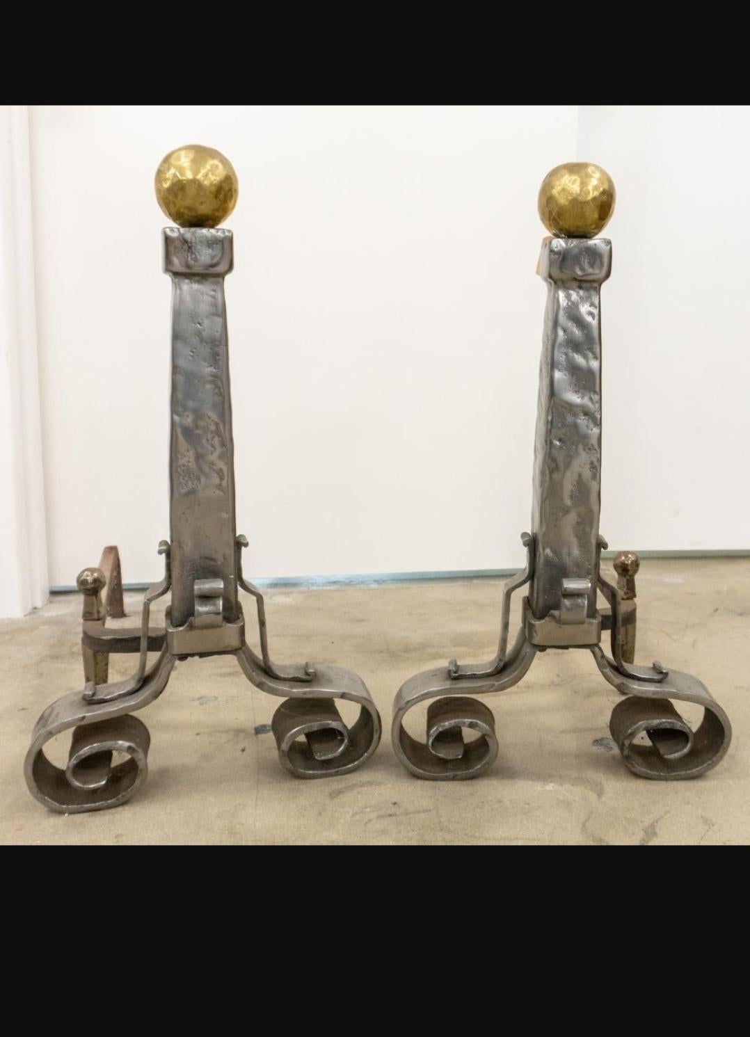 A Pair of Hammered Steel and Brass Andirons. Measures 10
