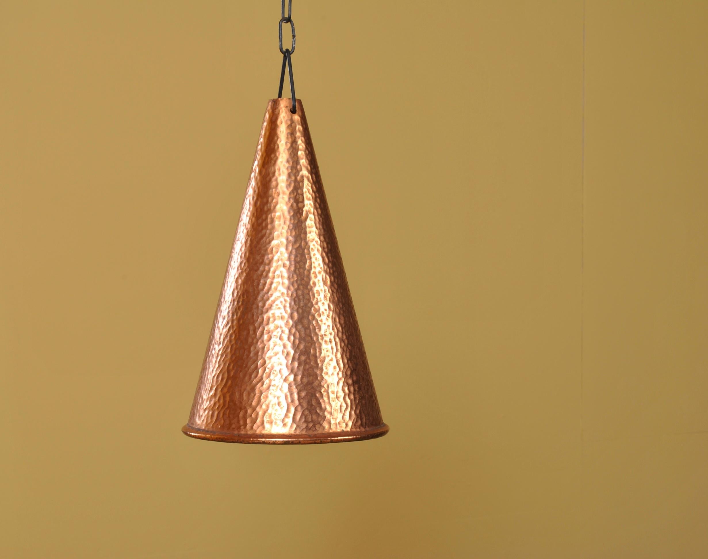 A pair of hand finished copper pendant shades. Made in Denmark in the early to mid 20th century. Chain hanging. Lovely patina and in good condition.
