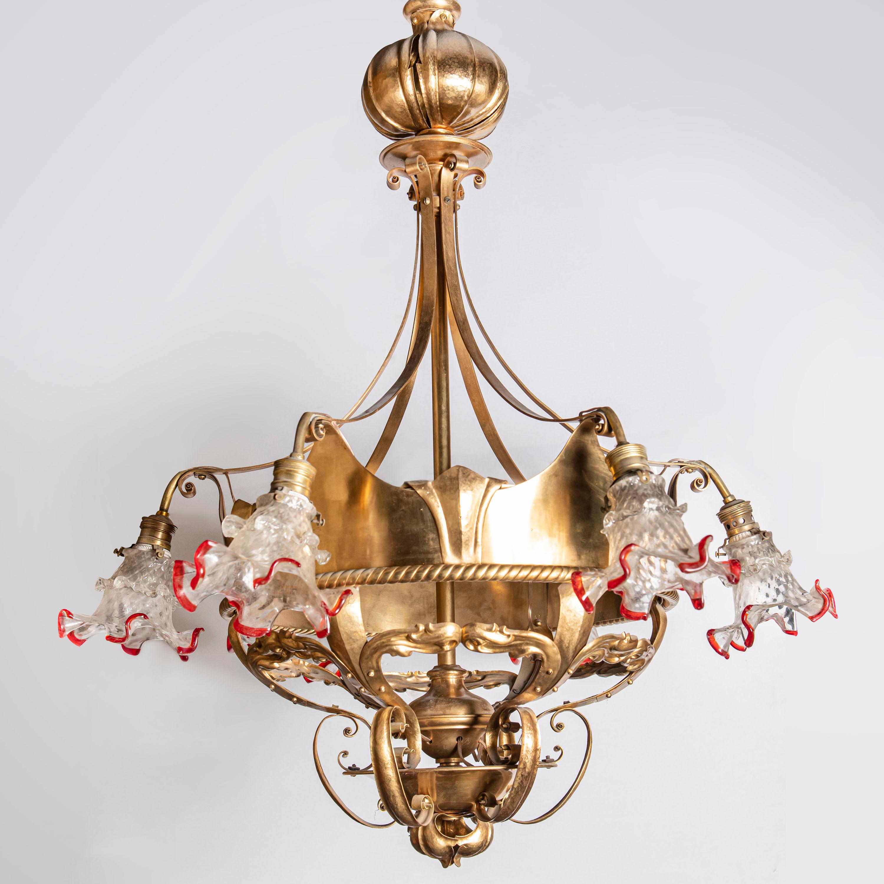 Pair of hammered gilt bronze and glass chandeliers. France, early 20th century.