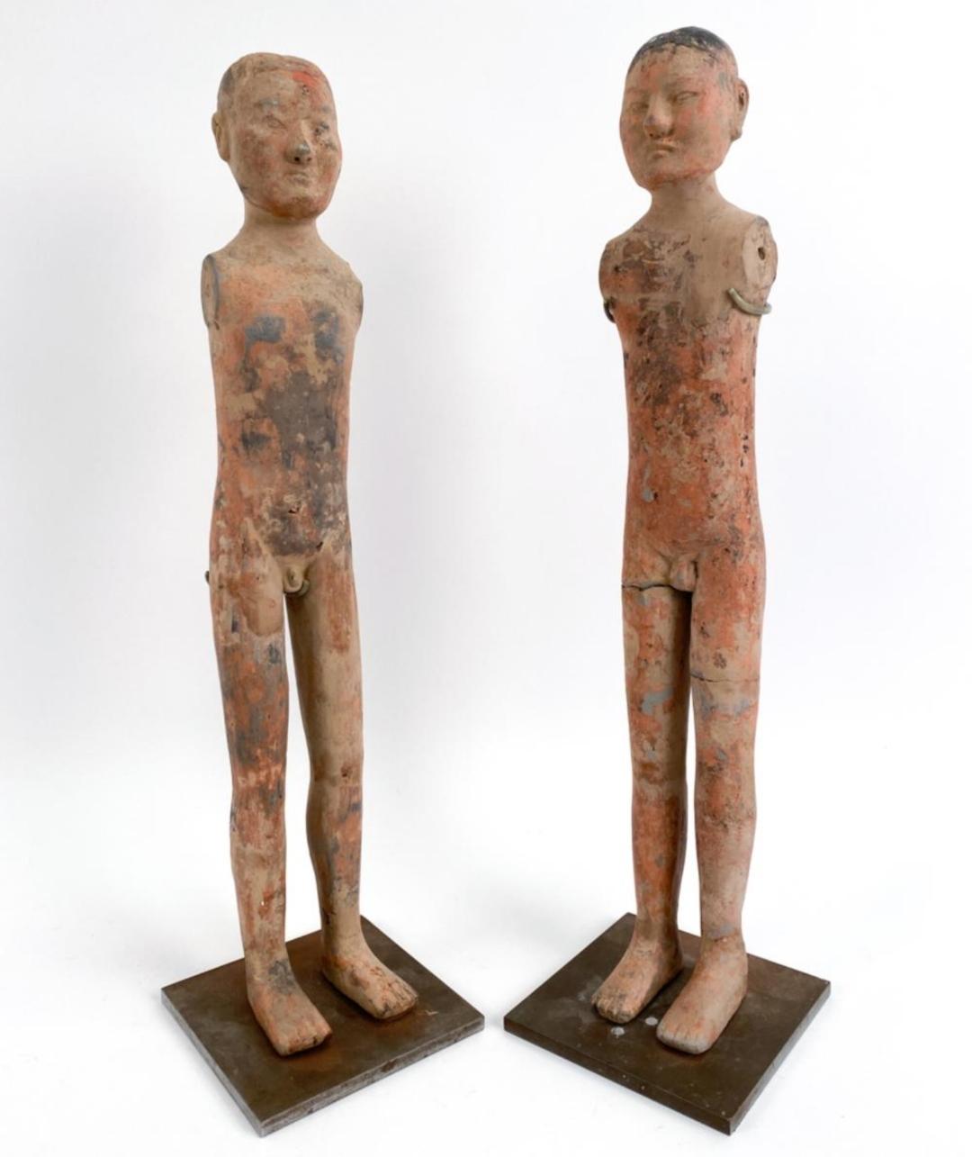 Pair of standing guardian figures in gray clay,with traces of polychrome. Dating to Han Dynasty, circa 2nd century BC. 
These rare figures are mounted on custom vintage stands. 
Dimensions: (Taller, figure 24.75