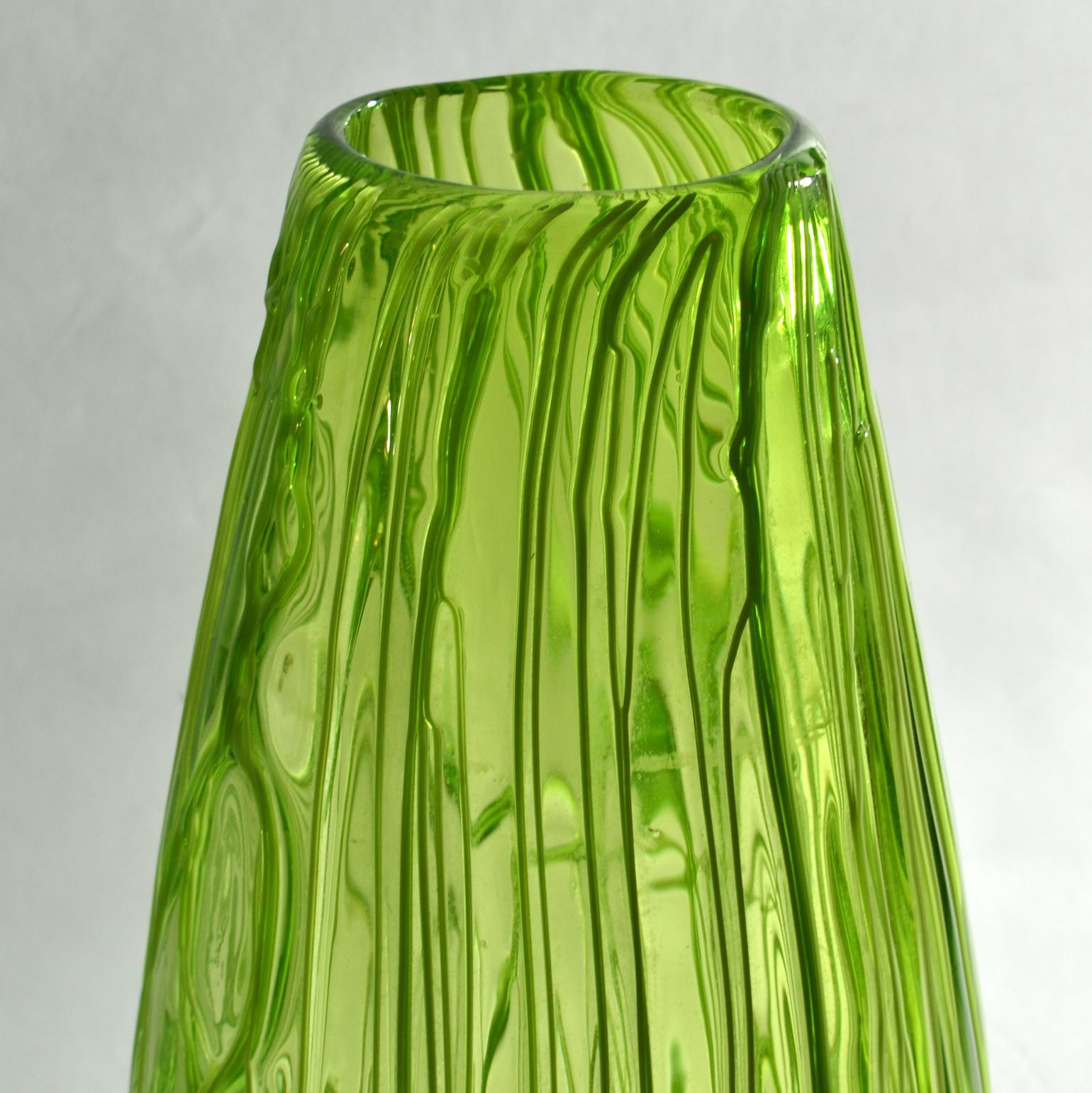 Cette paire de vases d'un vert pomme éclatant a été fabriquée selon la technique Caldo, souvent utilisée à Murano, qui consiste à faire courir des fils de spaghetti sur la surface, sur tout le corps, créant ainsi un relief texturé, au cours du