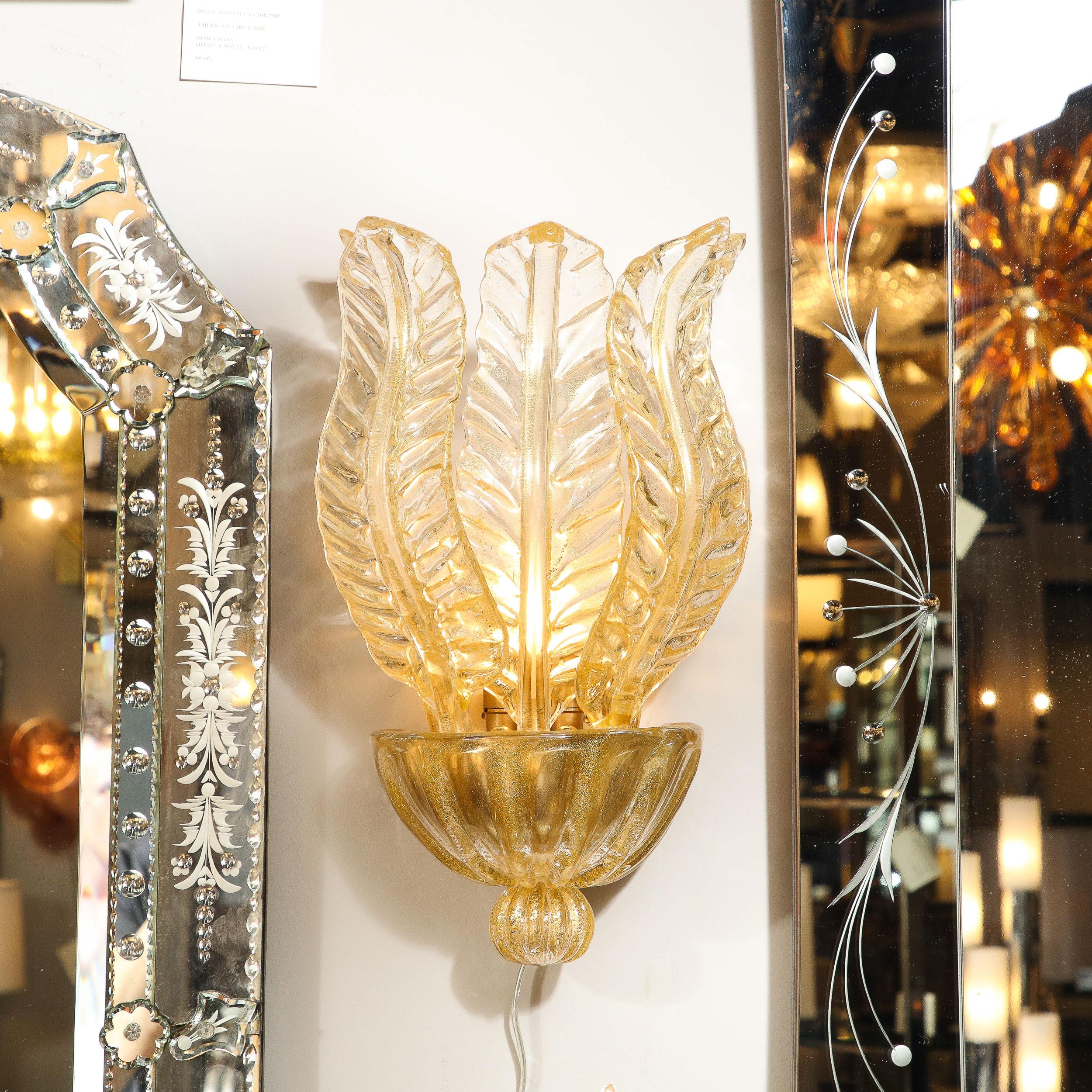 This stunning pair of modernist sconces were handblown in Murano, Italy- the island off the coast of Venice renowned for centuries for its superlative glass production- during the latter half of the 20th century. They feature domed and channeled