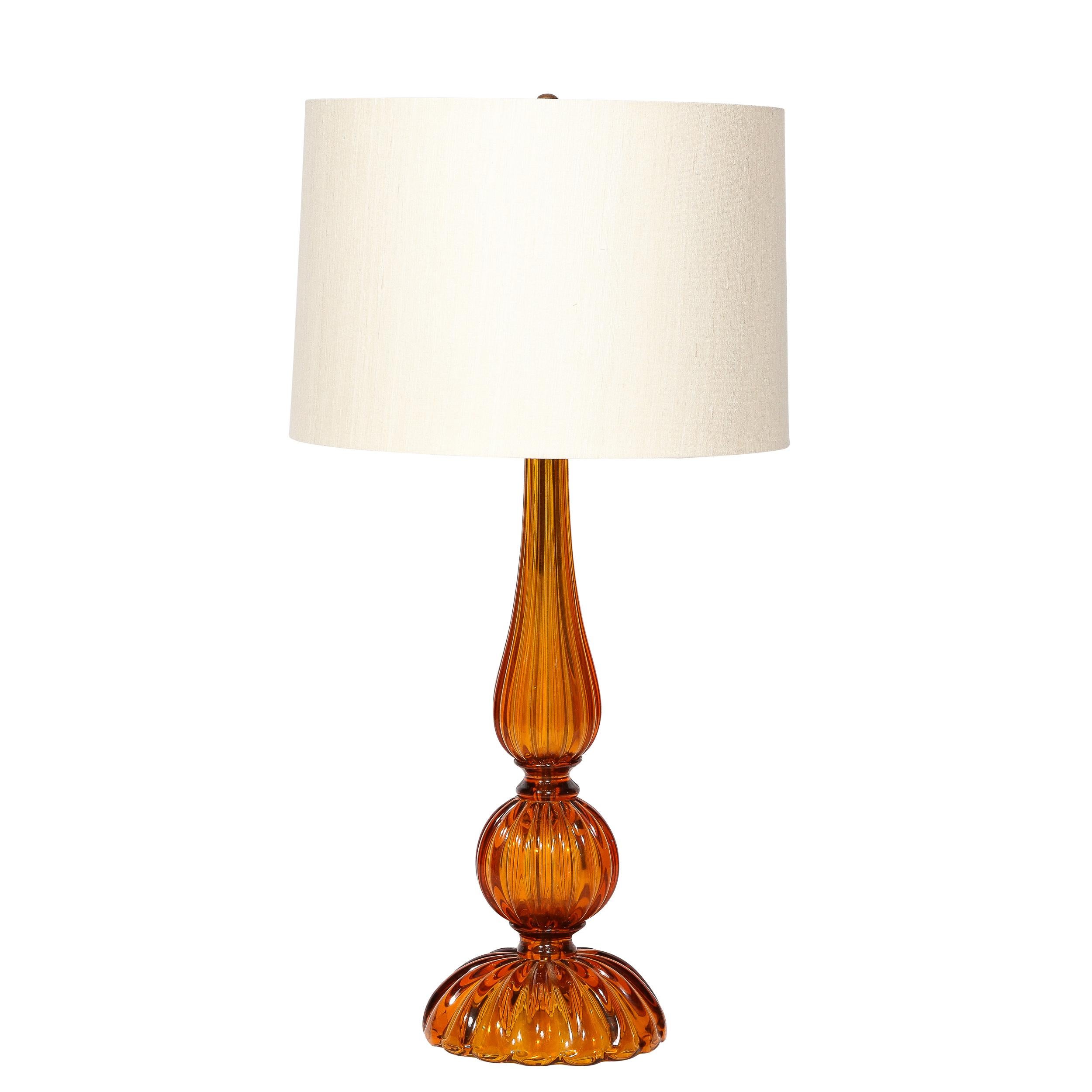 This beautiful pair of modernist table lamps were hand blown in Murano, Italy- the island off the coast of Venice renowned for centuries for its superlative glass production- during the second half of the 20th century. They feature sinuously curved,