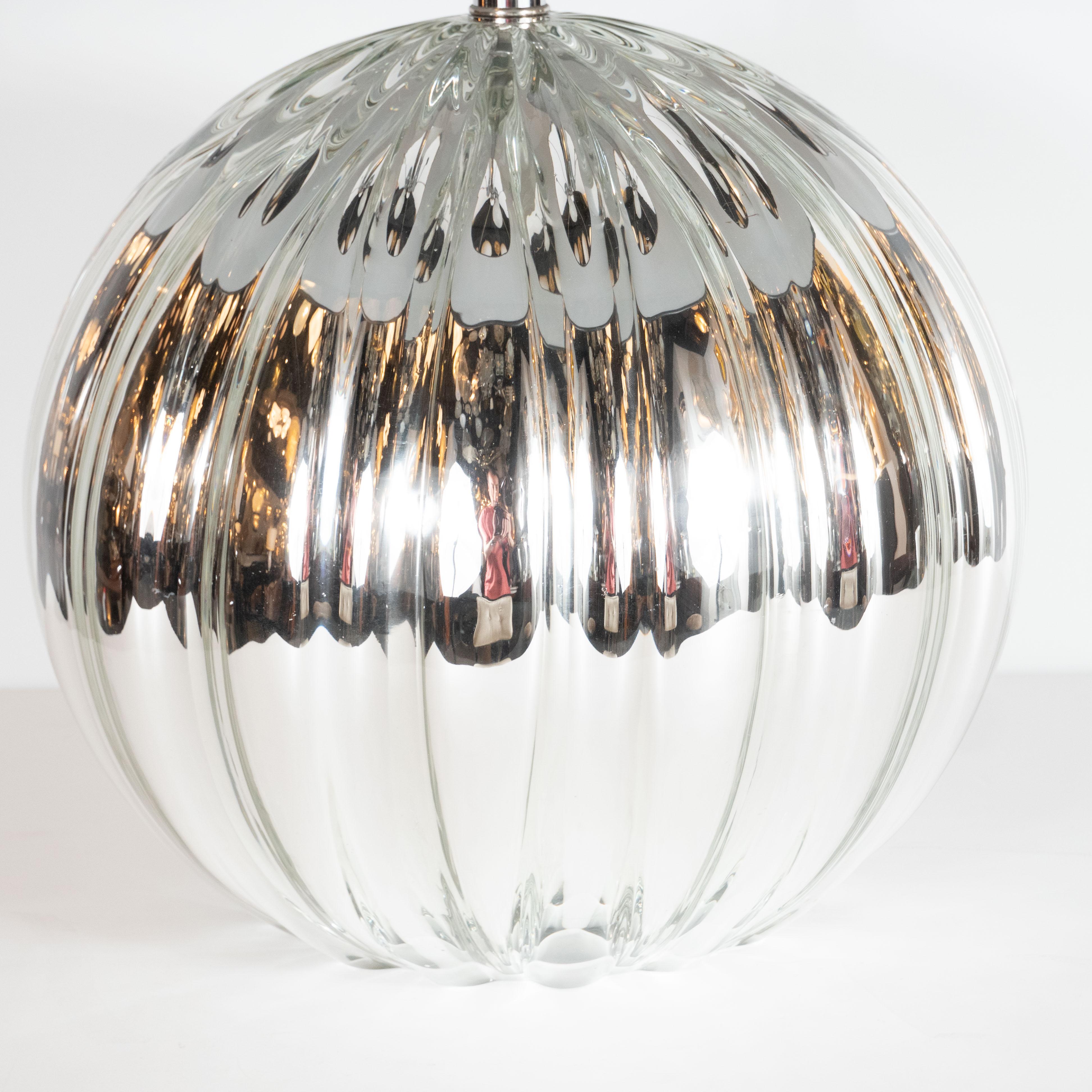 This gorgeous pair of table lamps were realized in Murano, Italy- the island off the coast of Venice renowned for centuries for its superlative glass products. Hand blown by artisans in lustrous and highly reflective Mercury, these lamps suggest