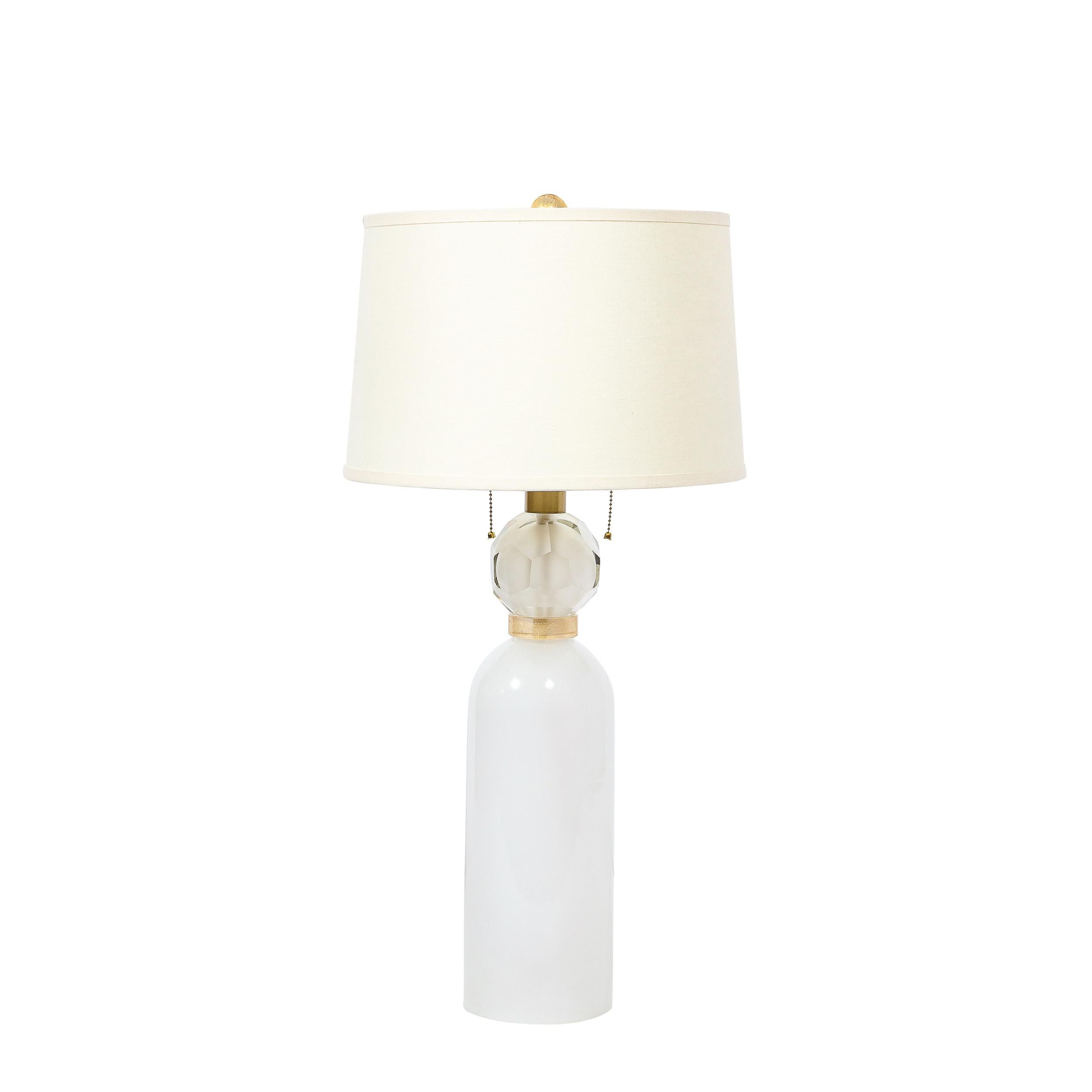 This stunning pair of modernist table lamps were hand blown in Murano- the island off the coast of Venice renowned for centuries for its superlative glass production. They feature cylindrical bullet form bodies that taper at their shoulders where