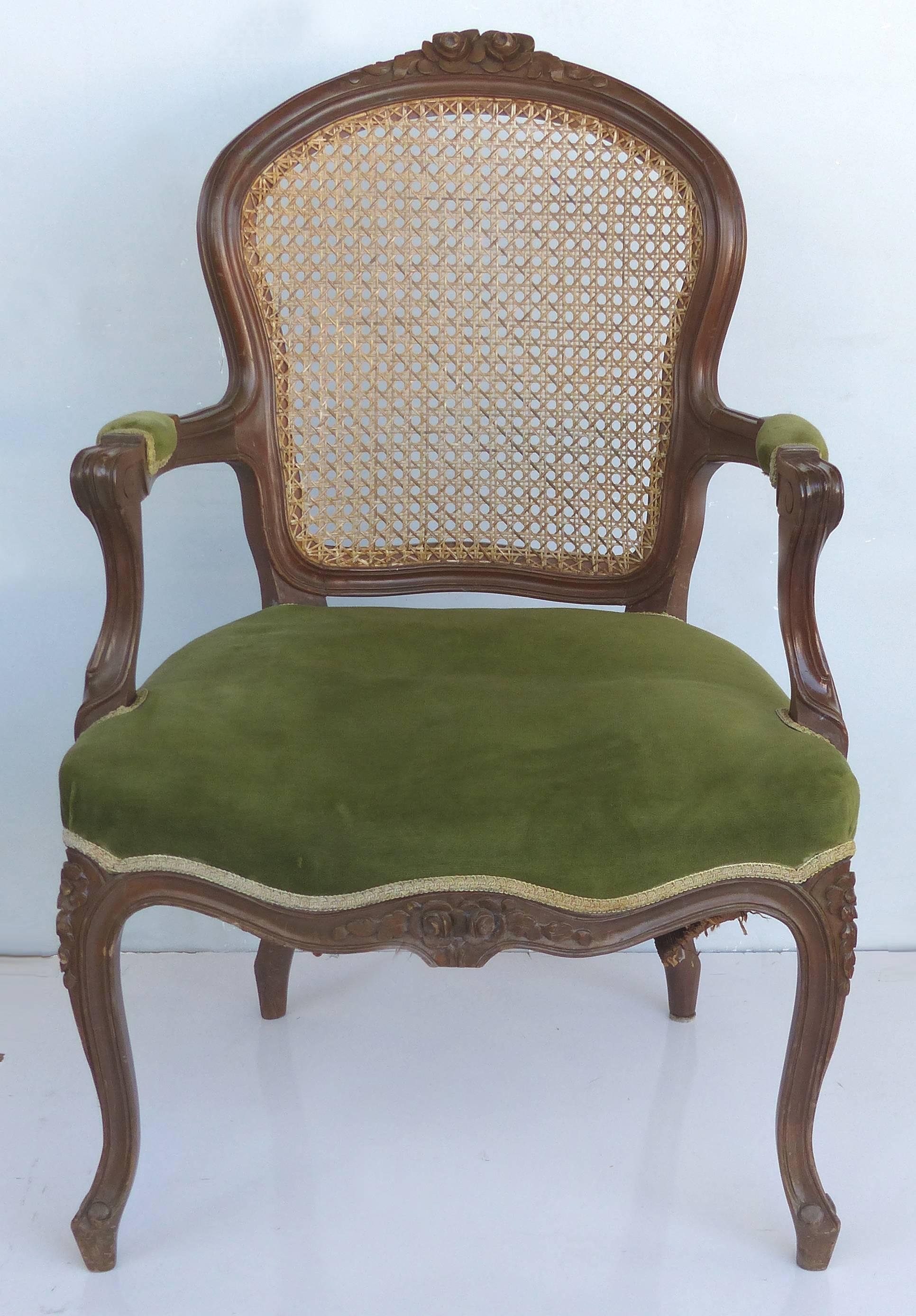 Offered for sale is a pair of French Louis XV style fauteuil armchairs with walnut frames, hand-caned backs and nicely upholstered seats with velvet mohair seats finished with a nice trim. Measure: Arm, 25