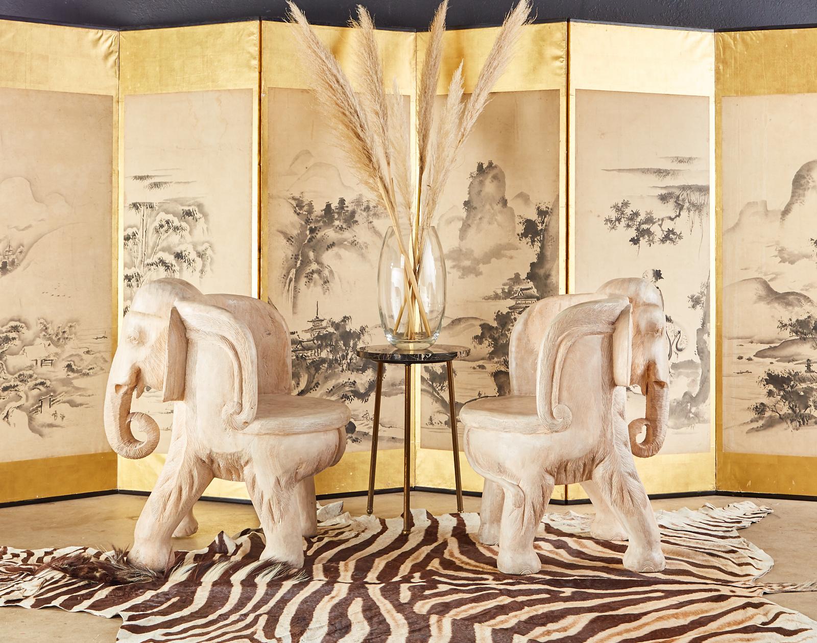 Charming pair of hand carved hardwood elephant chairs crafted from large tree trunks. Beautifully crafted with detailed faces and trunks. Featuring a white-washed or bleached finish that gives them an attractive patina but still showcases the