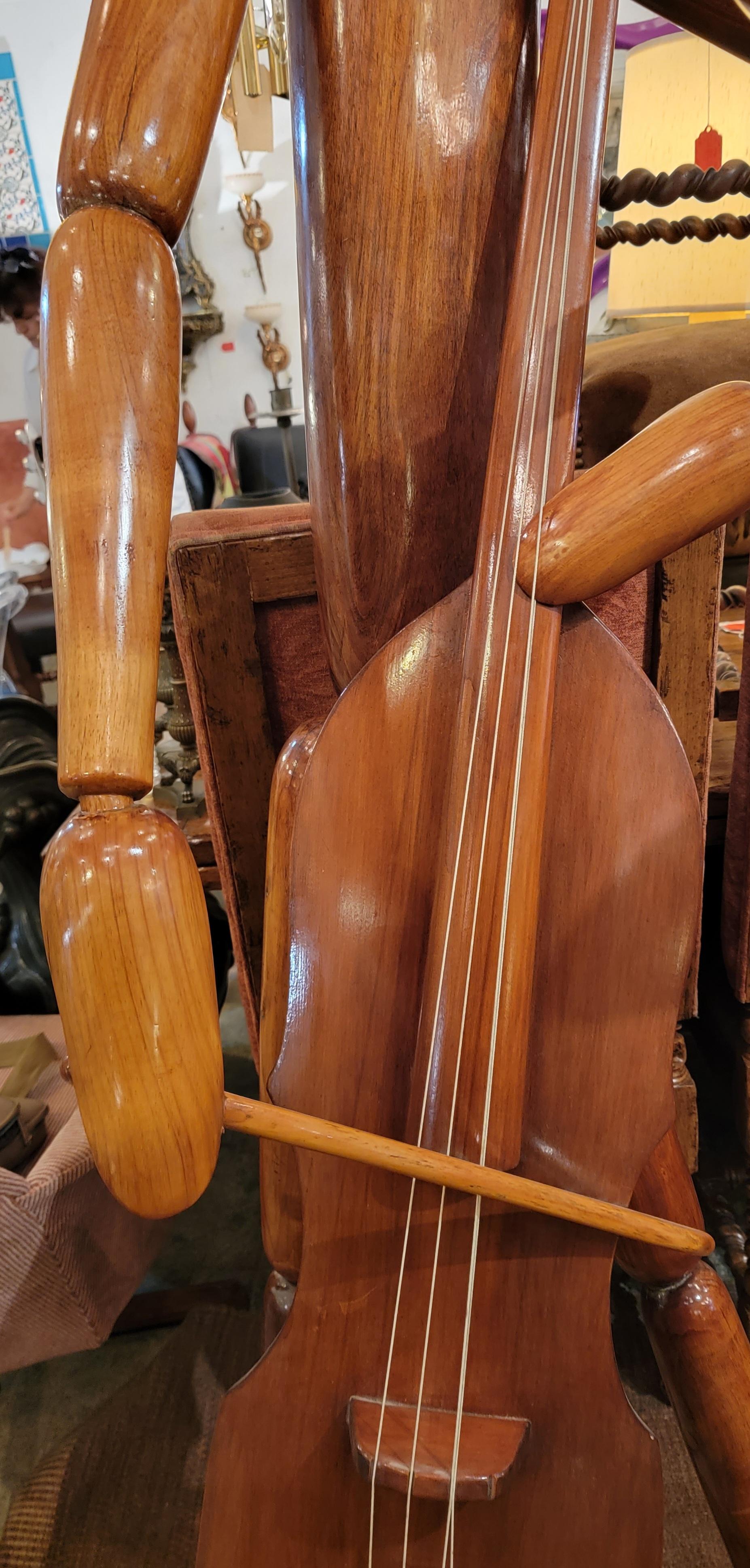 Pair of life sized carved sculptures made from wood. One is playing the violin and the other is reaching for a dance partner. Great polished wooden musicians.
 Larger sculpture measures - 77h x 30w x 20d

Smaller sculpture measures - 67h x  25w  36d