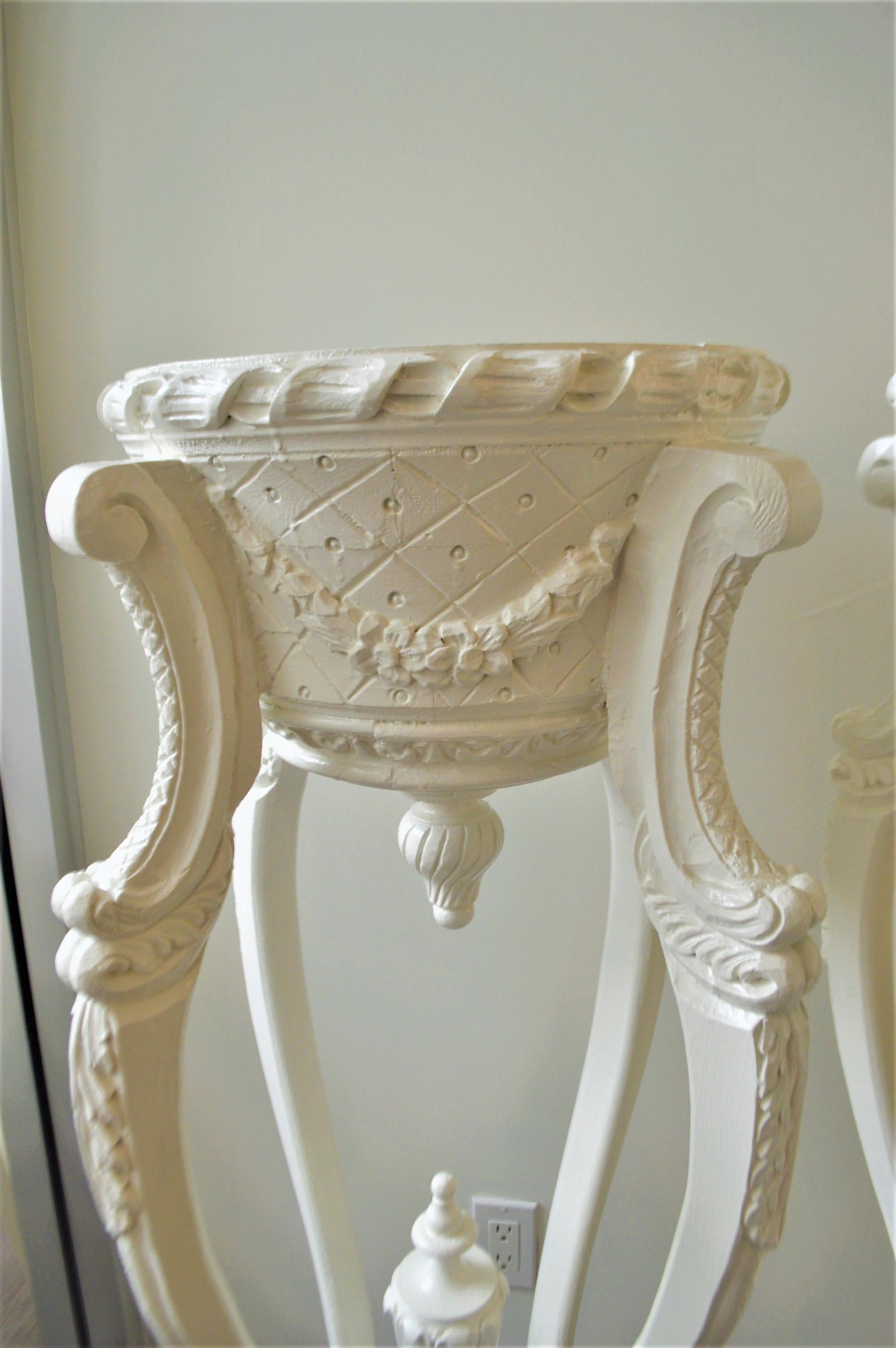 Most unusual pair of highly decorative white painted pedestals. They are versatile, with a marble top to display sculptures or without the marble will hold plants.
Great decorative pieces to flank entrance doors from a modern to traditional style