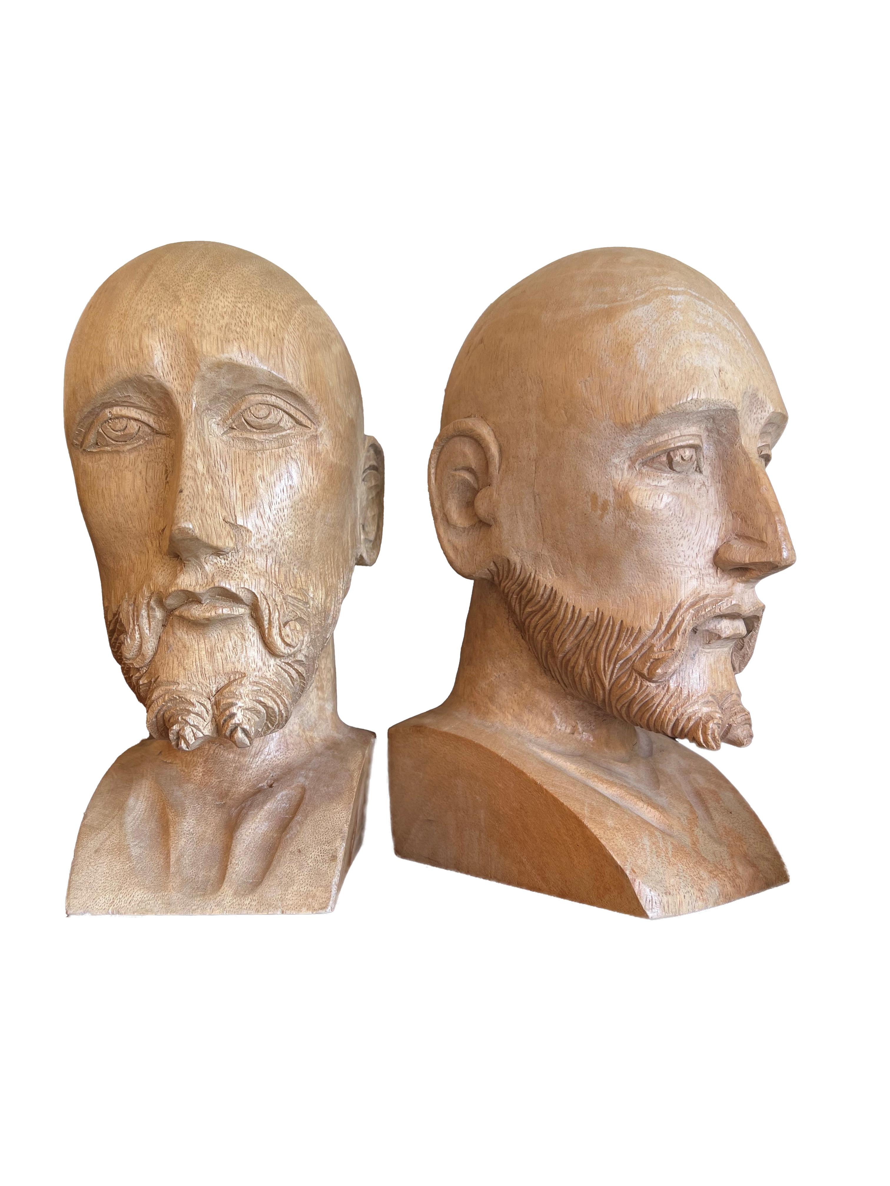Delve into the realm of exquisite craftsmanship and timeless artistry with this remarkable pair of hand-carved distinguished gentlemen. Each bust, unique in its depiction, captures the essence of character and sophistication through the masterful