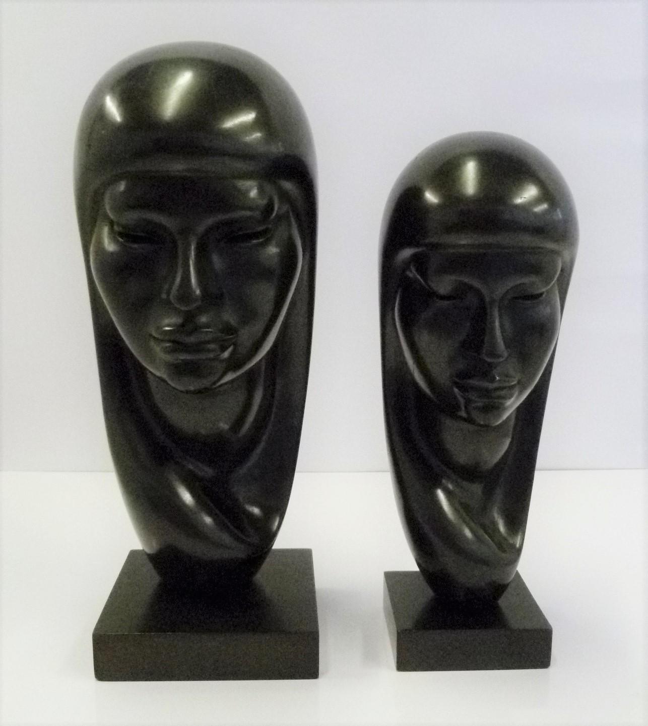 Bolivian wood sculptor G. Arias who was known for his ethnic art themes of the South American Aymara Indians from the 1950s. Two beautifully rendered depictions of native shrouded women hand carved in ebonized wood in two sizes. With a lovely smooth