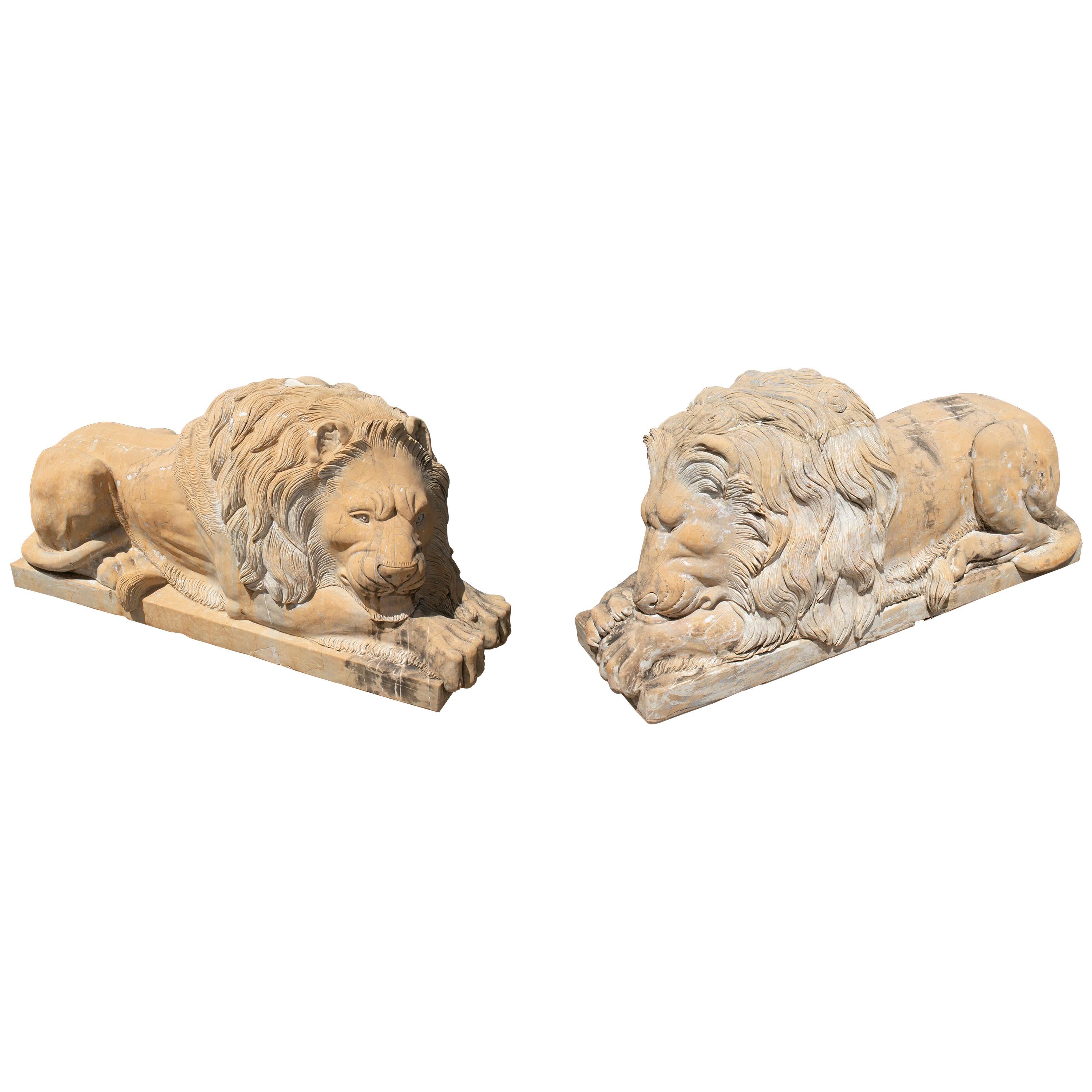 Pair of Hand Carved Giallo Cream Marble Lying Lions