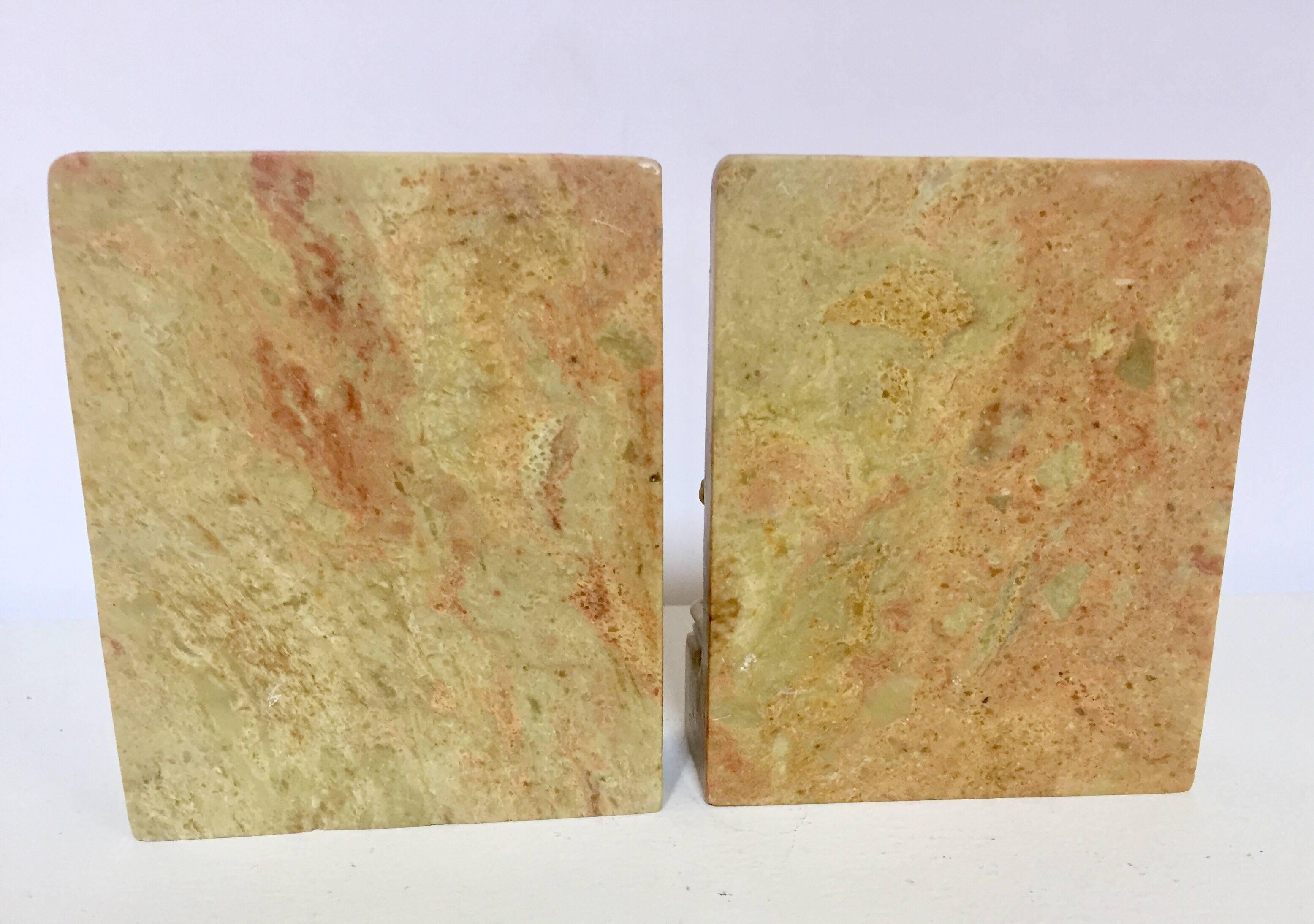 Pair of finely hand carved stone bookends featuring high relief landscape scene with dragon heads.
A very well done Chinese figural soapstone art object in carved green soapstone plaques bookends.
Great to use on a desk as a paper weight or