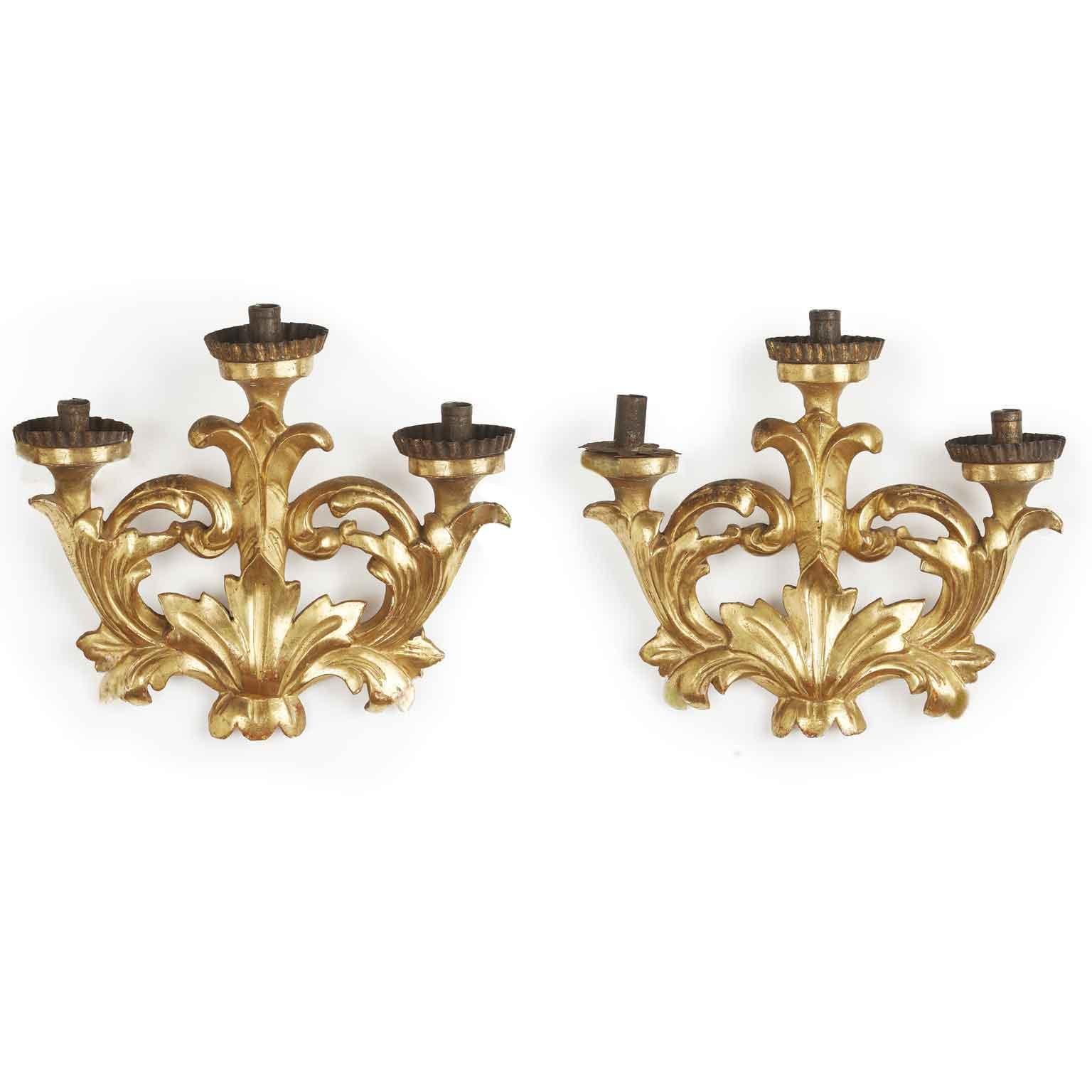 Pair of gold-leaf gilded friezes suitable for three-light sconces, of Italian origin dating back to mid 19th century.They are elements of a pyramid the socalled liturgical altar candelabra featuring several lights, usually seven, arranged in a