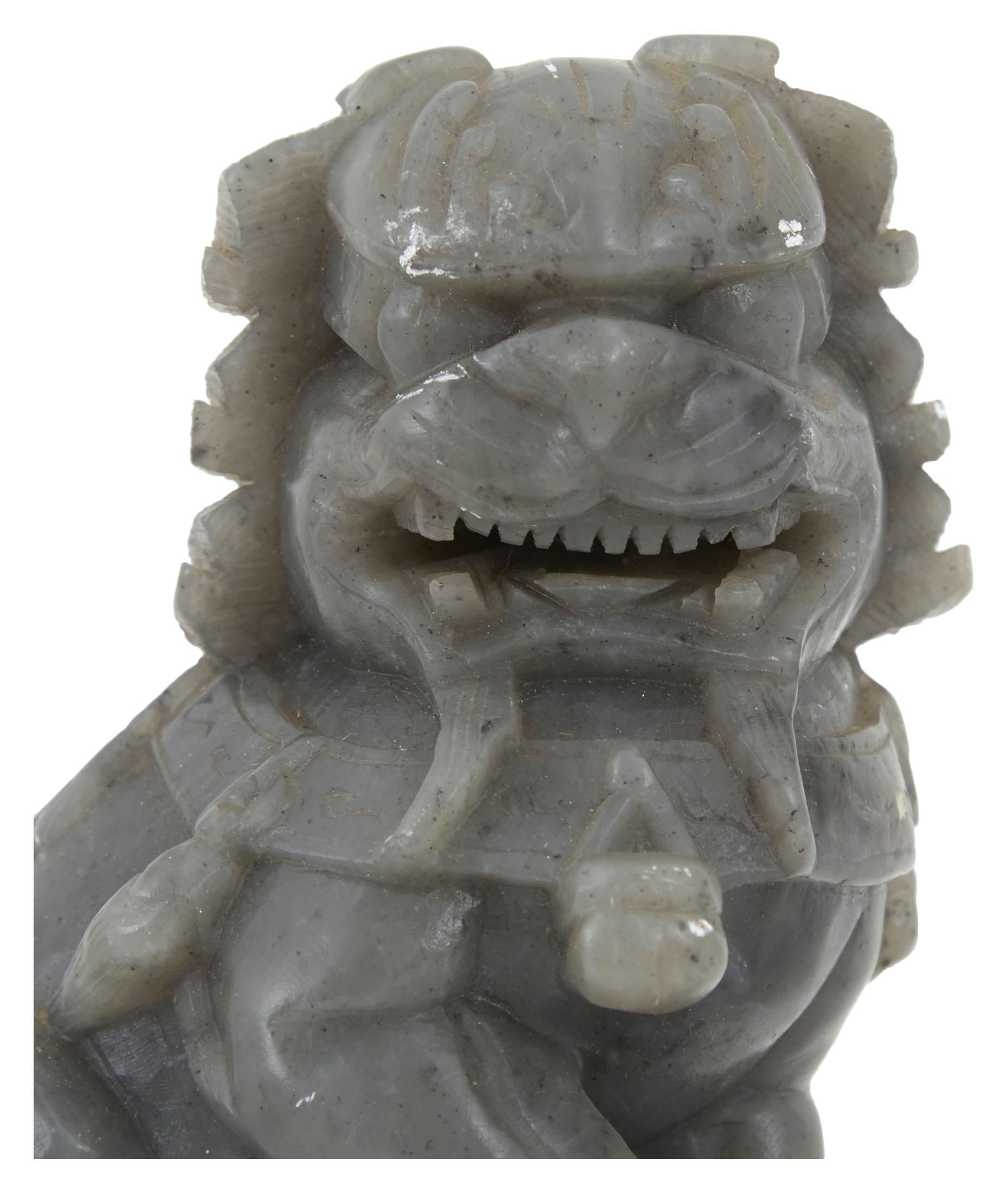 Our vintage foo dog statues were hand carved in China in the early 20th century. Also known as Imperial guard lions, statues similar to these have stood guard at the entrances of Chinese palaces, temples, tombs and government offices for centuries.