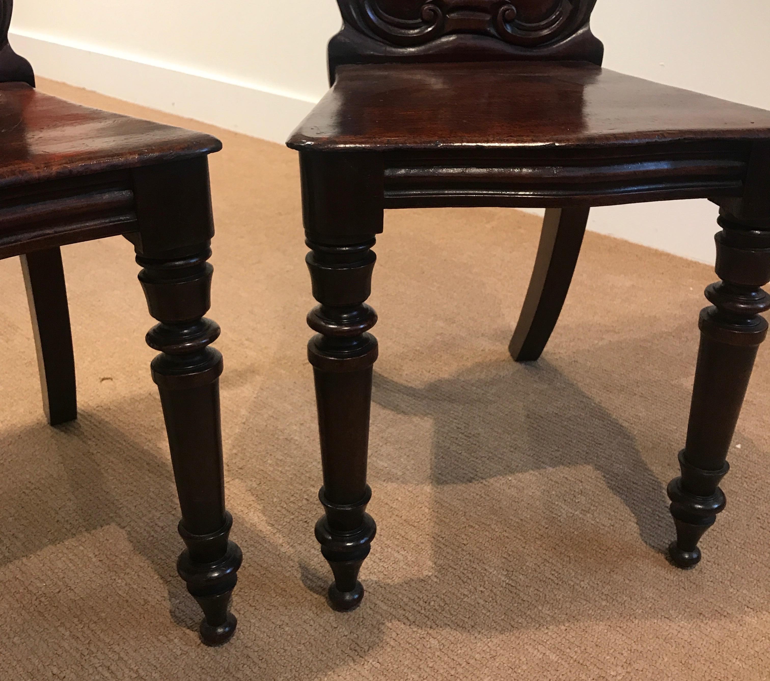 English Pair of Hand Carved Mahogany Armorial Hall Chairs For Sale