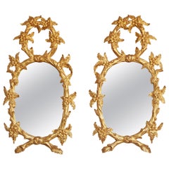 Pair of Hand Carved Oval Gilt Wood Mirrors by La Maison London