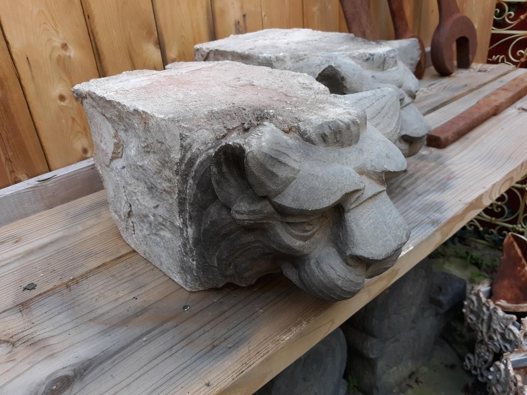 A Pair of limestone lion heads which are architectural remnants from a late 19th Century building or structure. These are solid and heavy and are hand carved around 1885.