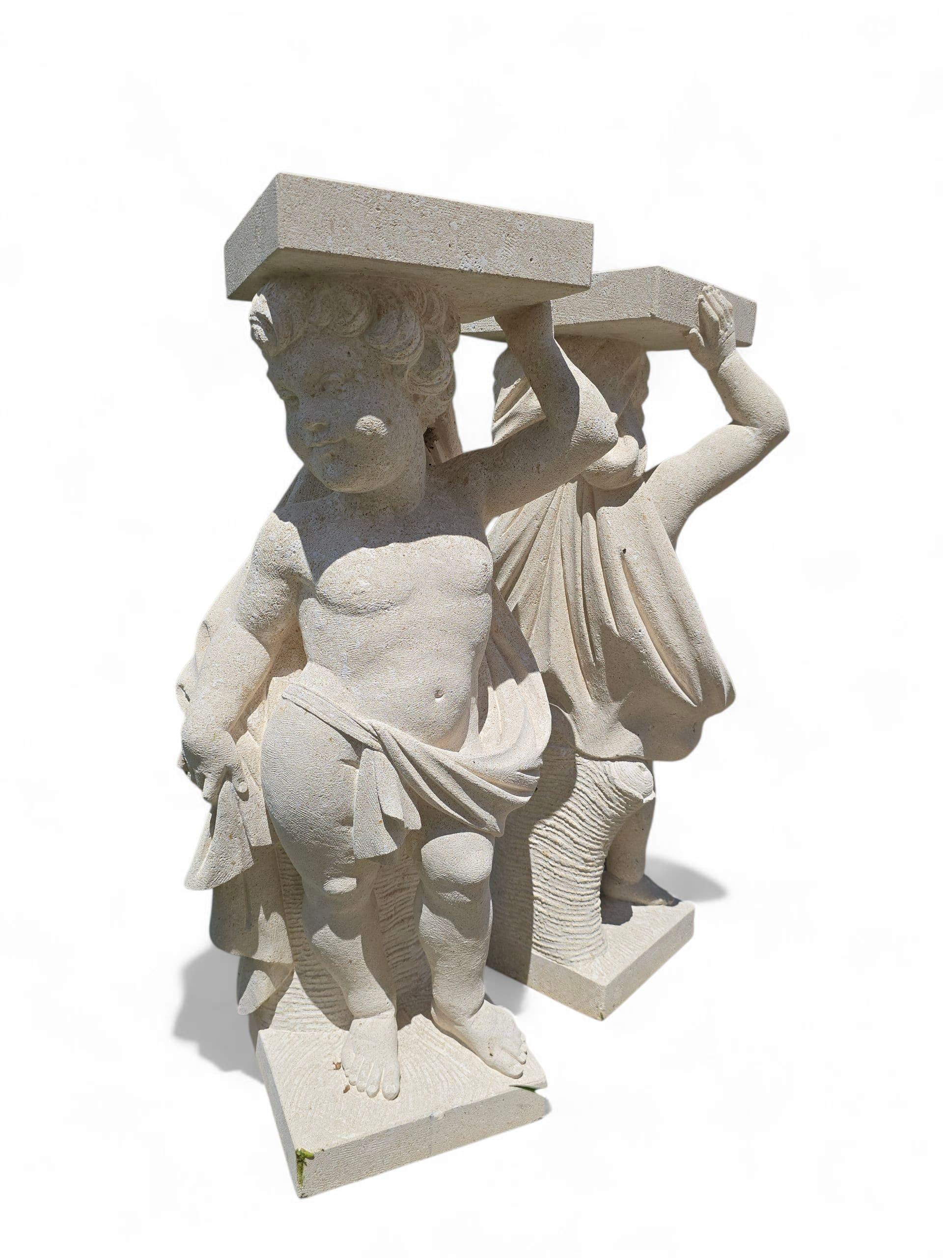 Beautiful pair of large cherub sculptures, hand-carved from traditional Vicenza stone in Italy. These expressive angelic figures are depicted with soft features, curled hair, and flowing drapery, showcasing the craftsmanship and sculptural tradition