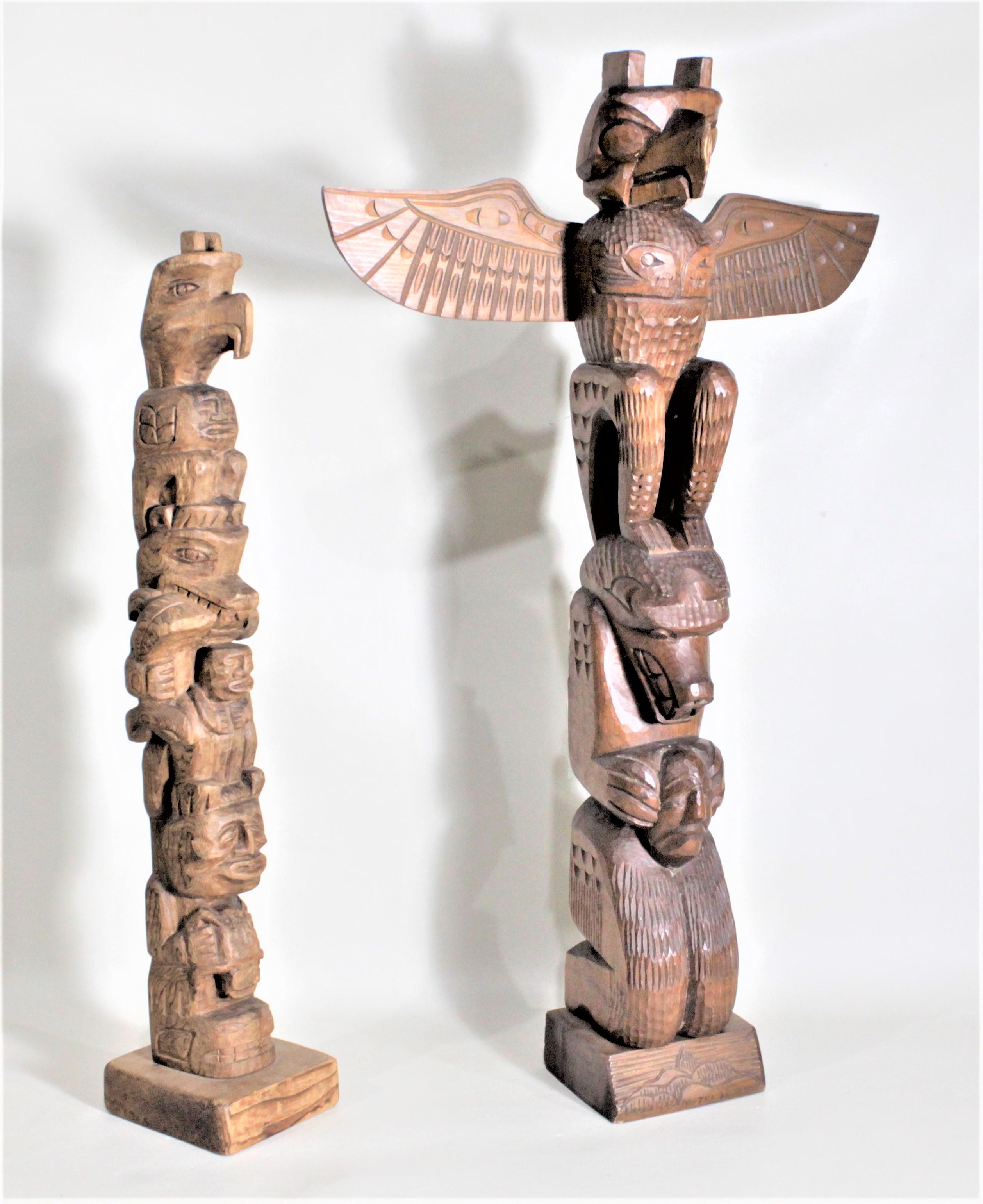 This pair of hand carved cedar TOTEM Poles were presumed to have been done in circa 1965 in the West Coast Canadian Indigenous Haida and Nootka styles respectively. The larger of the two TOTEM Poles has a label that identifies it as being carved by