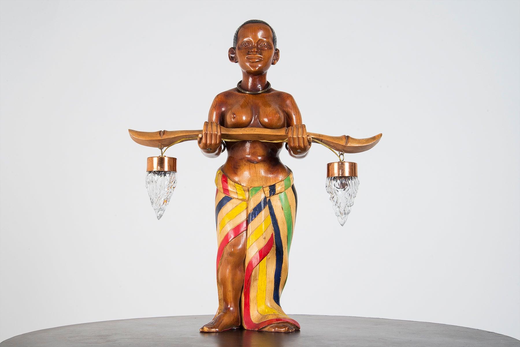 Pair of impressive large hand carved table lamps manufactured in Italy in the 1950s. One represents an African woman carrying two water jars, while the second one depicts a Chinese man in his traditional clothes with two lanterns (each one carries a