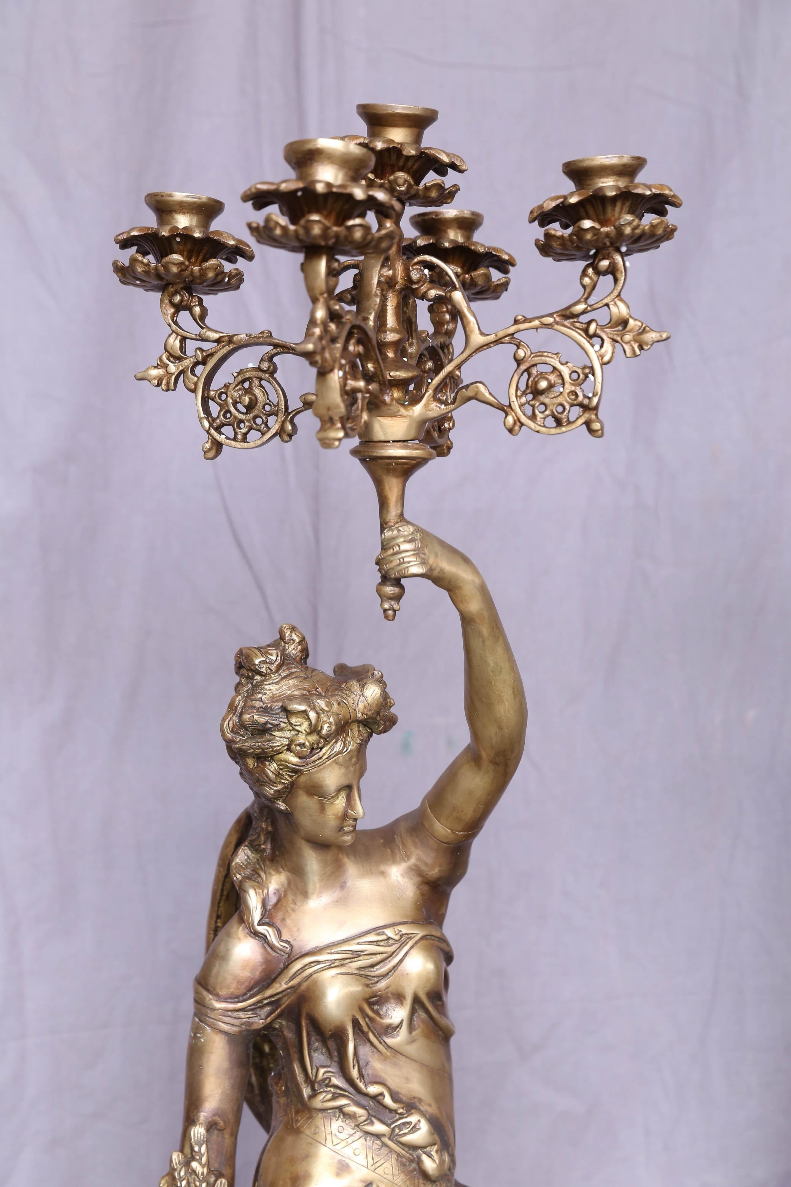 These fine hand cast bronze ladies holding candelabras were made in the late 20th century. These pieces will adorn any entry hall. These can be used also in front of fire places. After casting these figures were hand chiseled to get the right form
