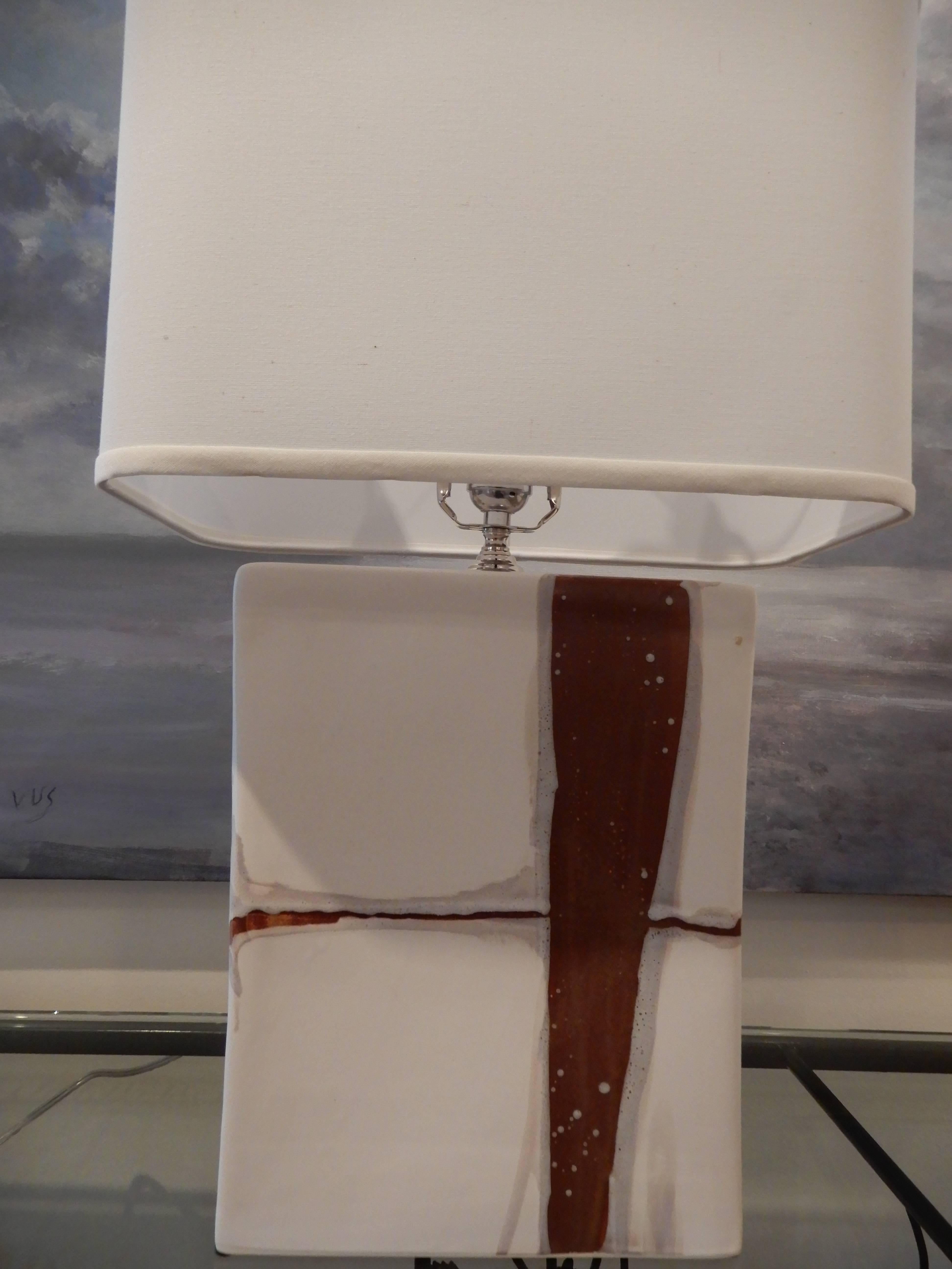 Pair of handcrafted artisan modern lamps.
Glazed ceramic with hand painted art work.
A white linen rectangle shade. Three way switch, two available, made to order.