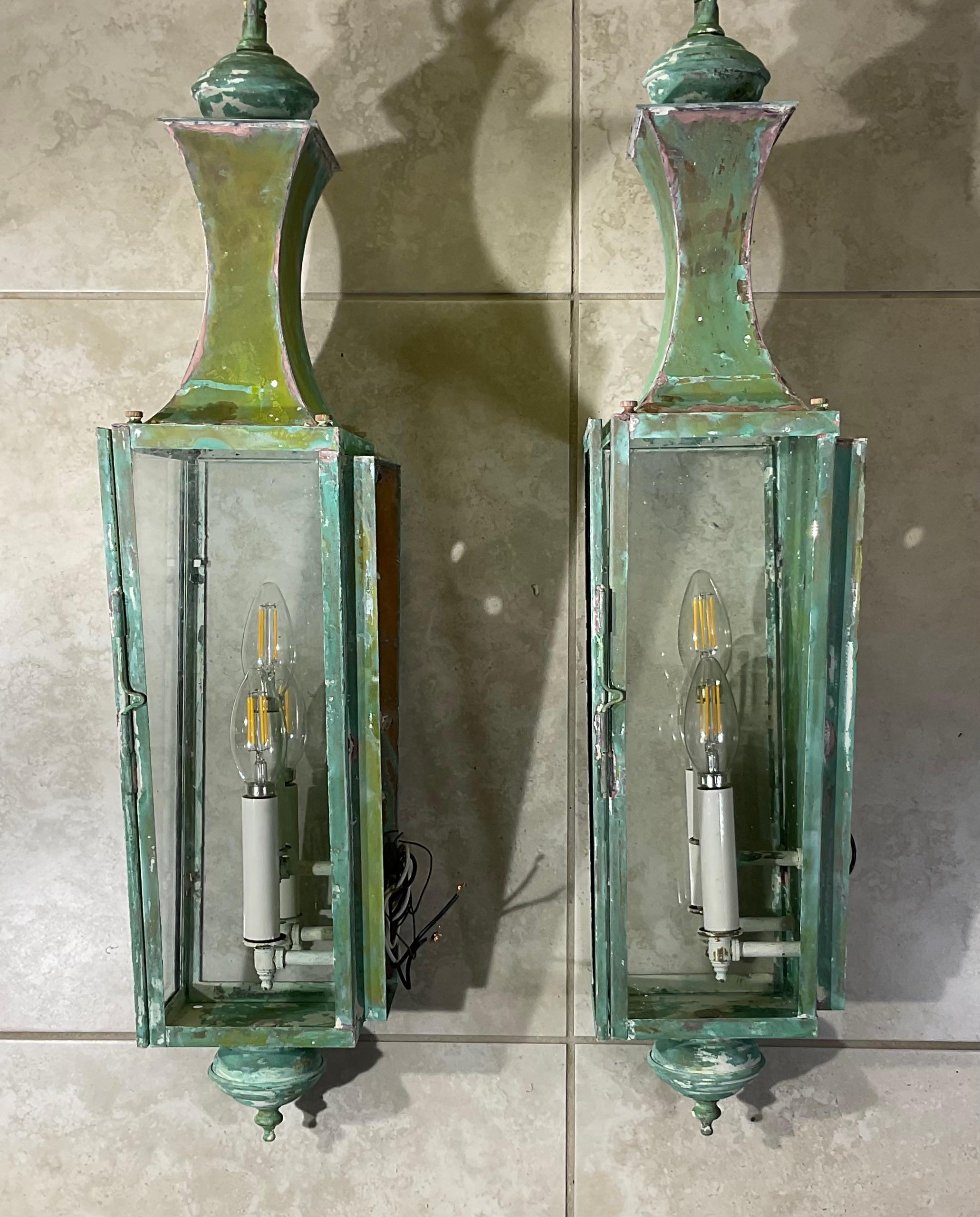 Elegant Pair of  wall hanging lantern , hand crafted from solid copper , with three 60/watt light each lantern , beautiful green patina .
Suitable for wet locations, made in the US .