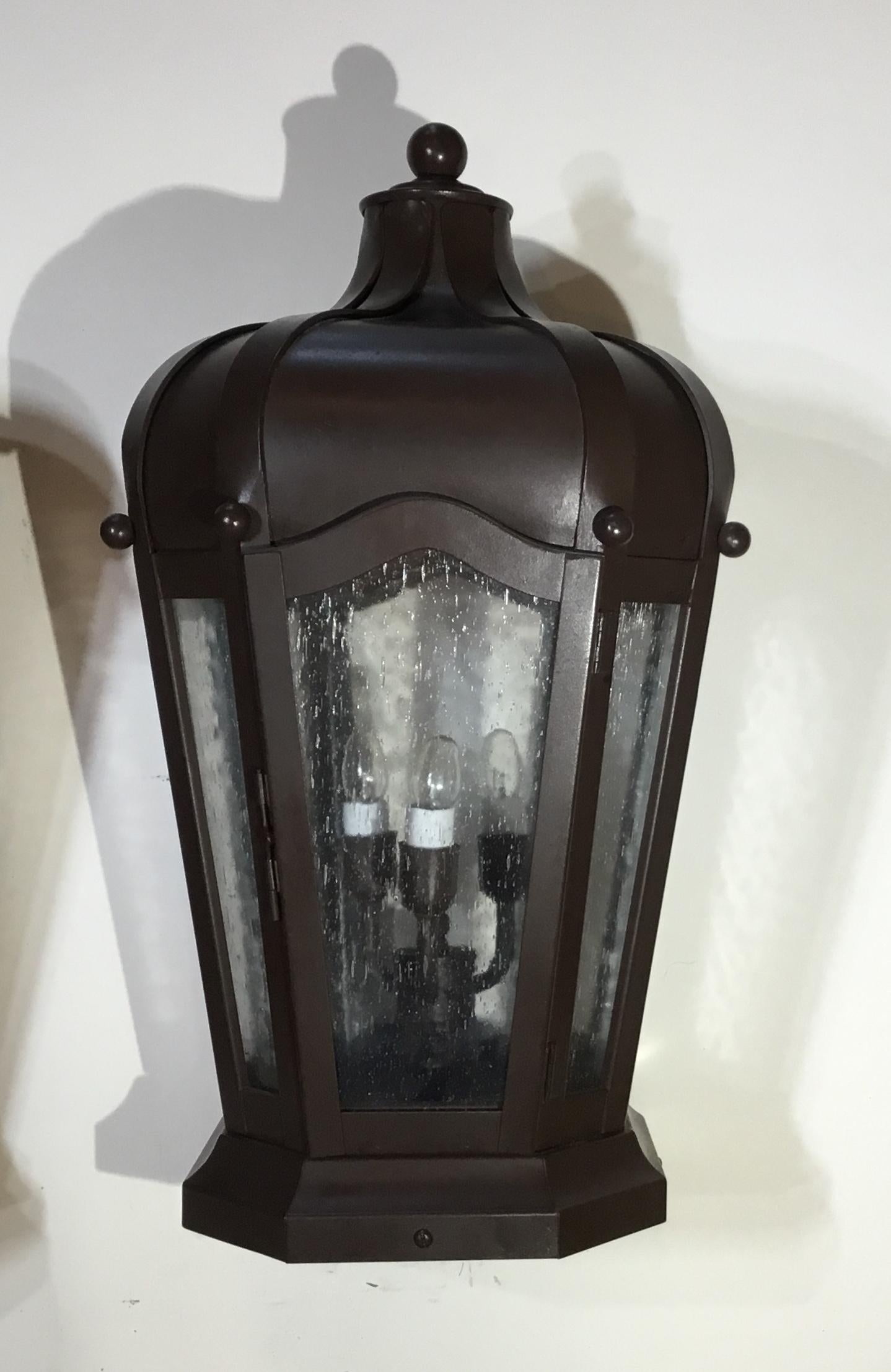 Decorative pair of post lantern artistically handcrafted from solid brass, seeded glass, with three 40/watt lights each, suitable for wet locations up to US Code very easy installation, professional brown finish.
Base size: 9” x 9”.
