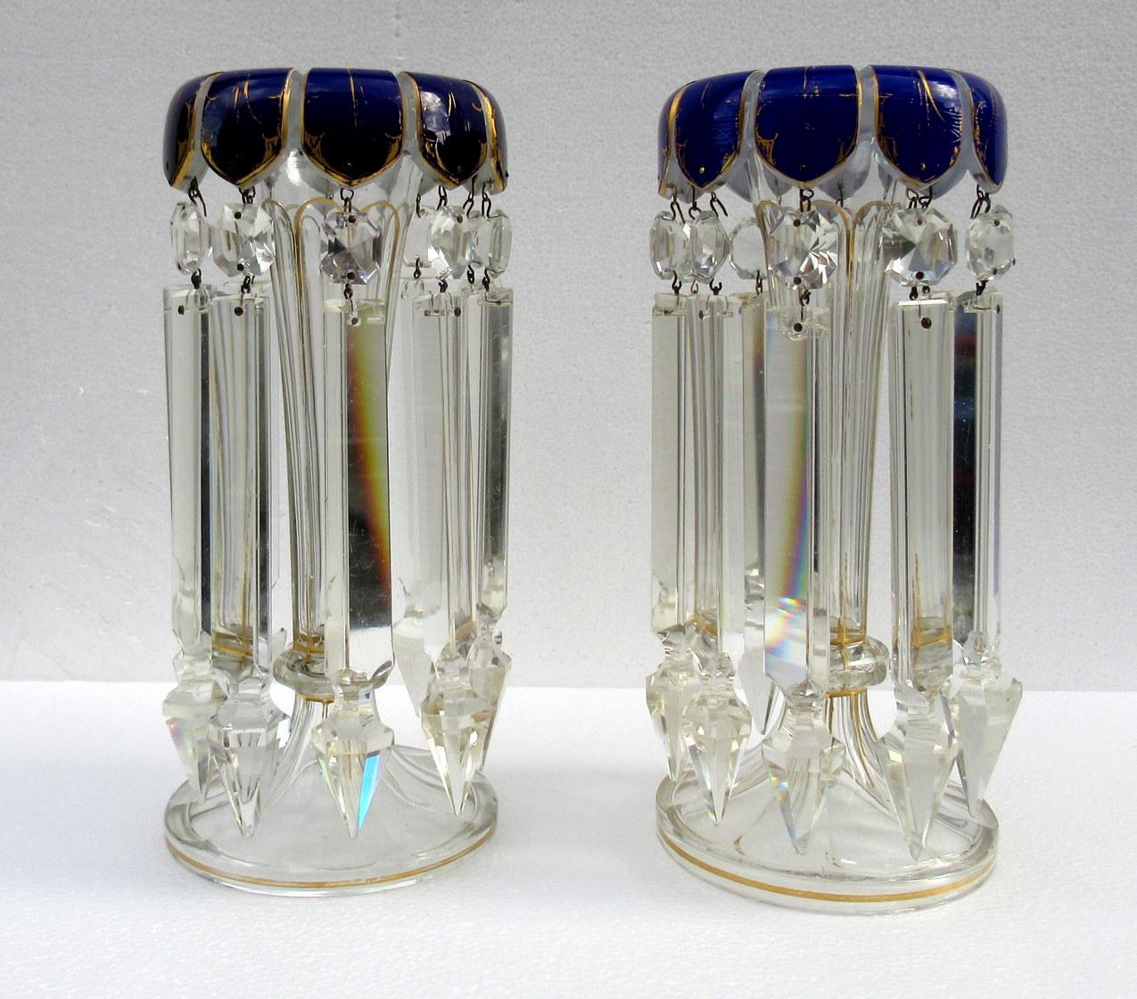 

A Stylish Example of a Fine Pair of Bohemian Gilt Heightened Enameled Hand Cut Full Lead Crystal Lusters of standard proportions. Third Quarter of the Nineteenth Century, possibly earlier. 

Each with unusual ovoid circular central supports