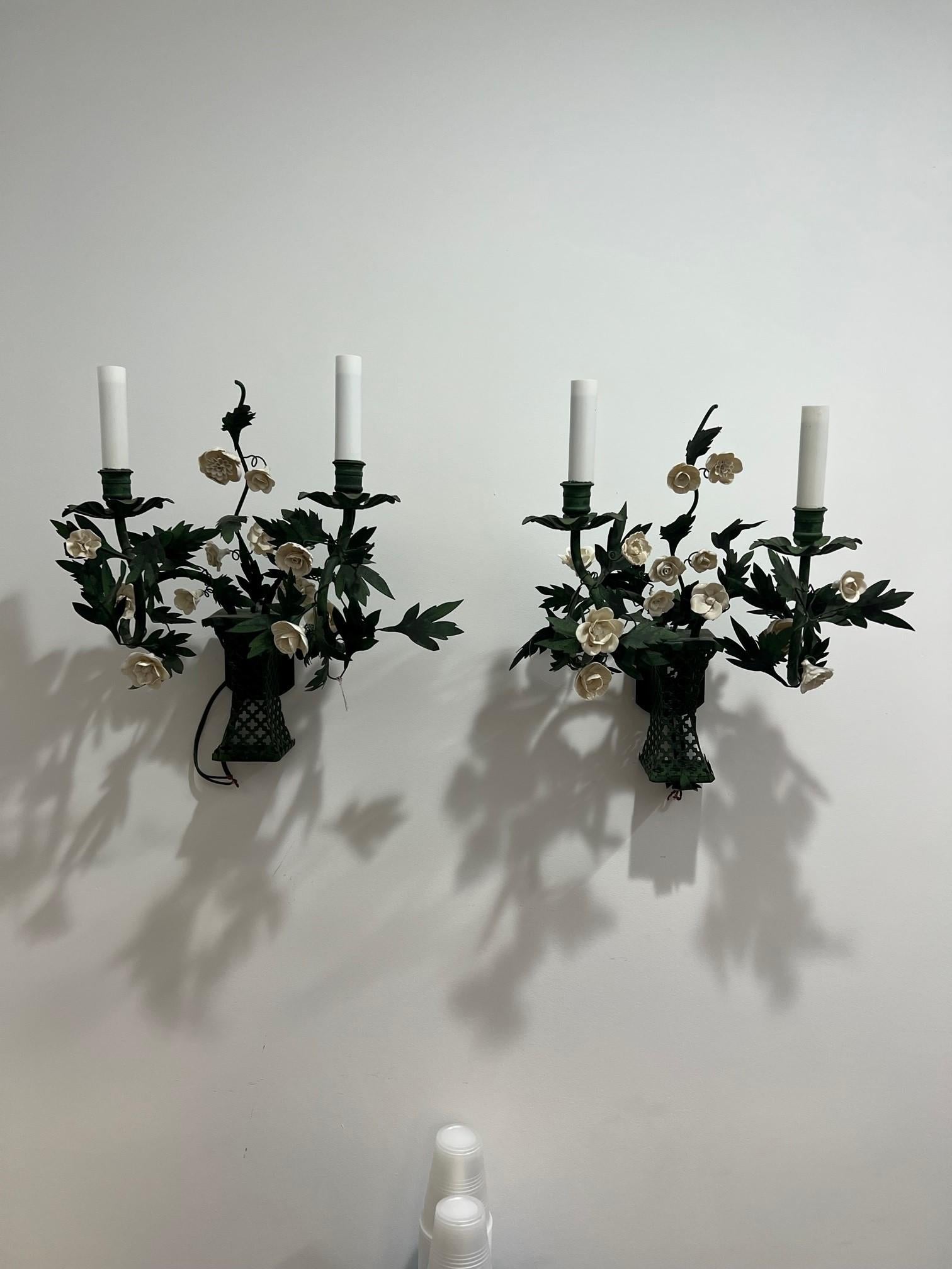 A nice pair of wall sconces with green metal leaves and white porcelain flowers handmade in France by Art el Floritude a well known manufacturer of lighting. This charming craft production will bring in your interior a little piece of nature. Each