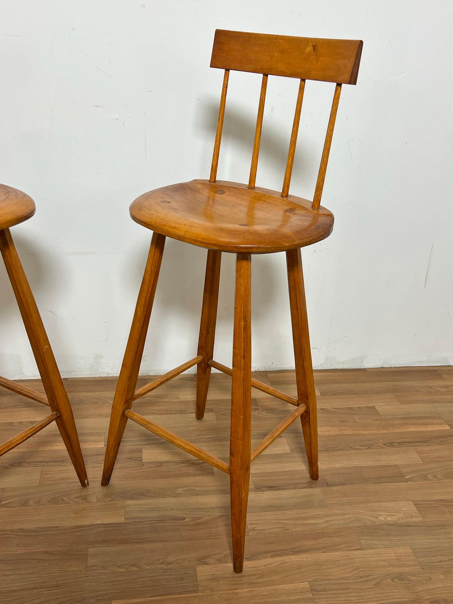 A pair of handmade studio craft bar stools in maple by the Boston area woodworker Bill Woodhead, dated 1985.