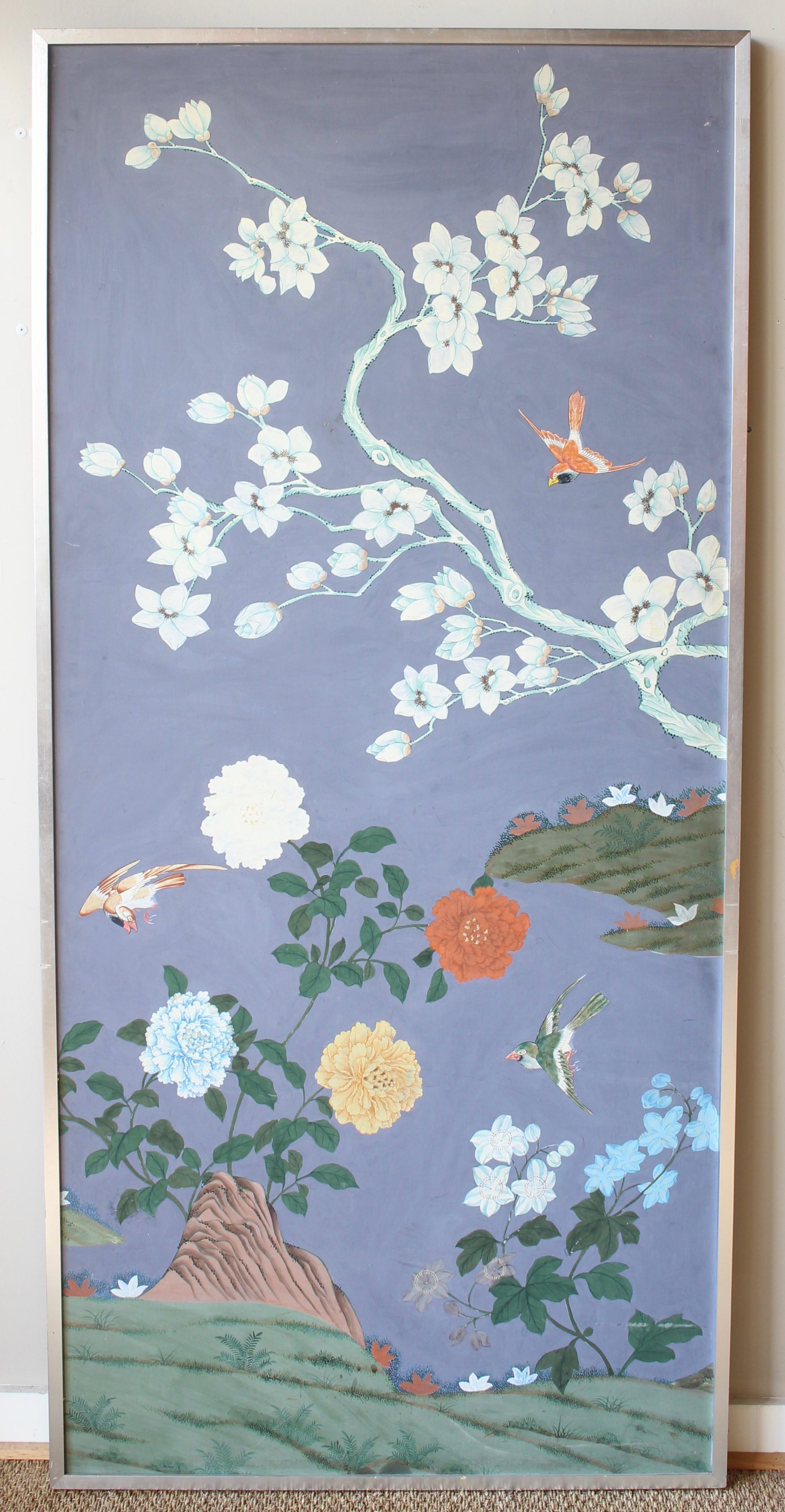 A pair of early 20th century Chinese hand painted wallpaper panels applied to board in original silver leafed wood frames.