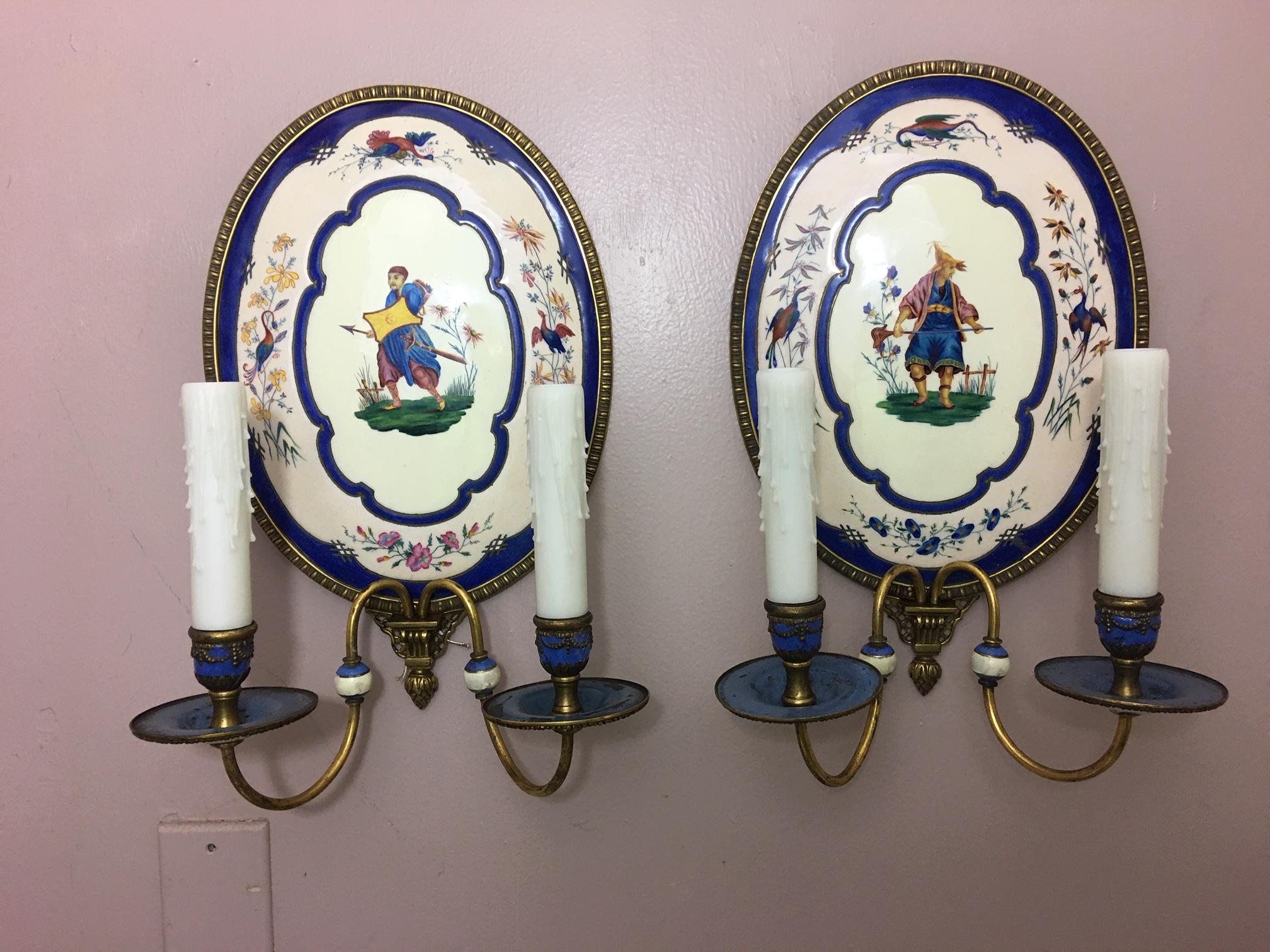 Pair of hand painted enamel two light sconces with figures, early 20th century.