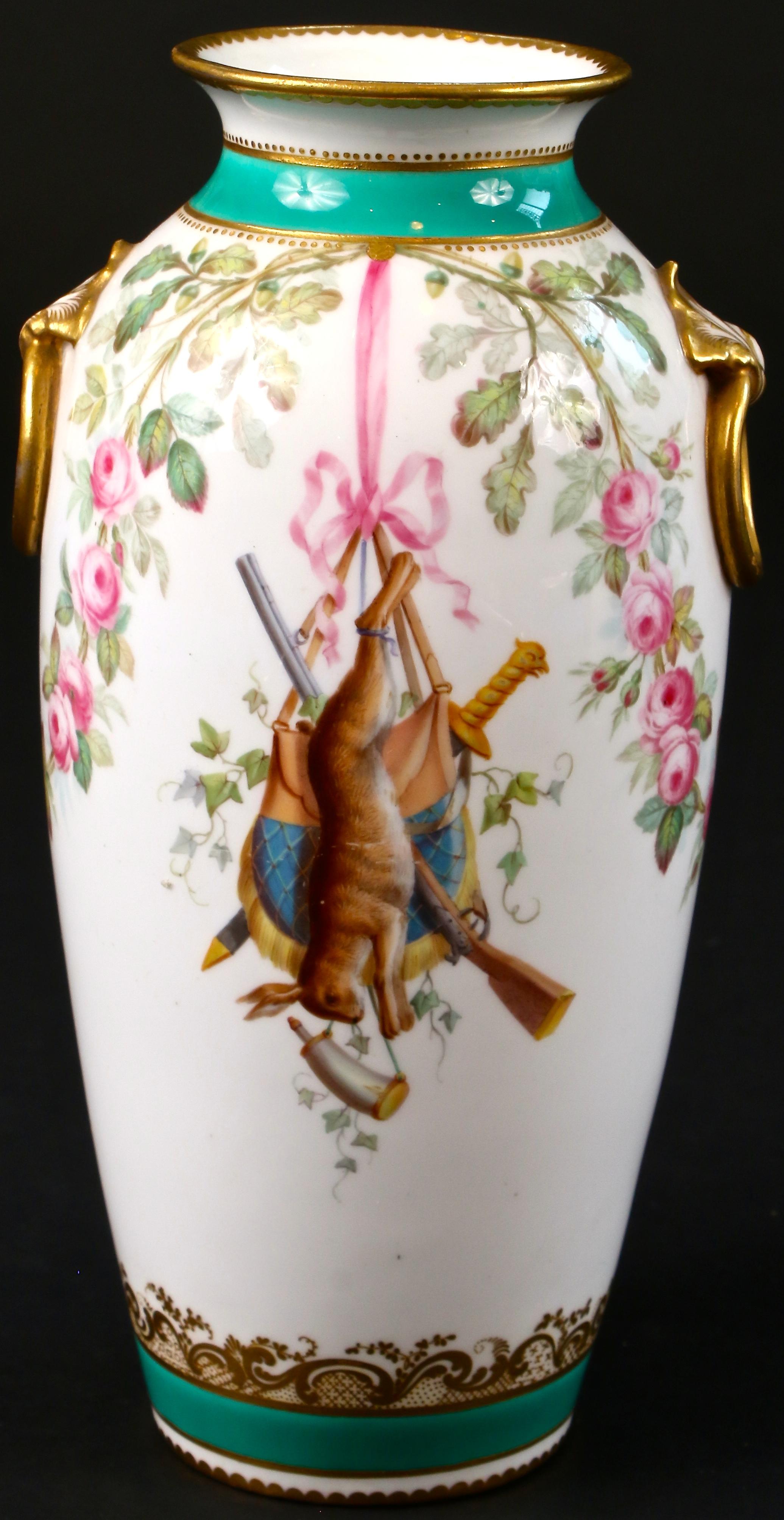 Here is a charming pair of hand painted trophy vases by Minton, Stoke-on-Trent, England. The painting on these vases exhibits a high level of artistry:
- a strung-up hare, rifle, hunting bag and sword, 
- 2 trophies of game birds hanging by their