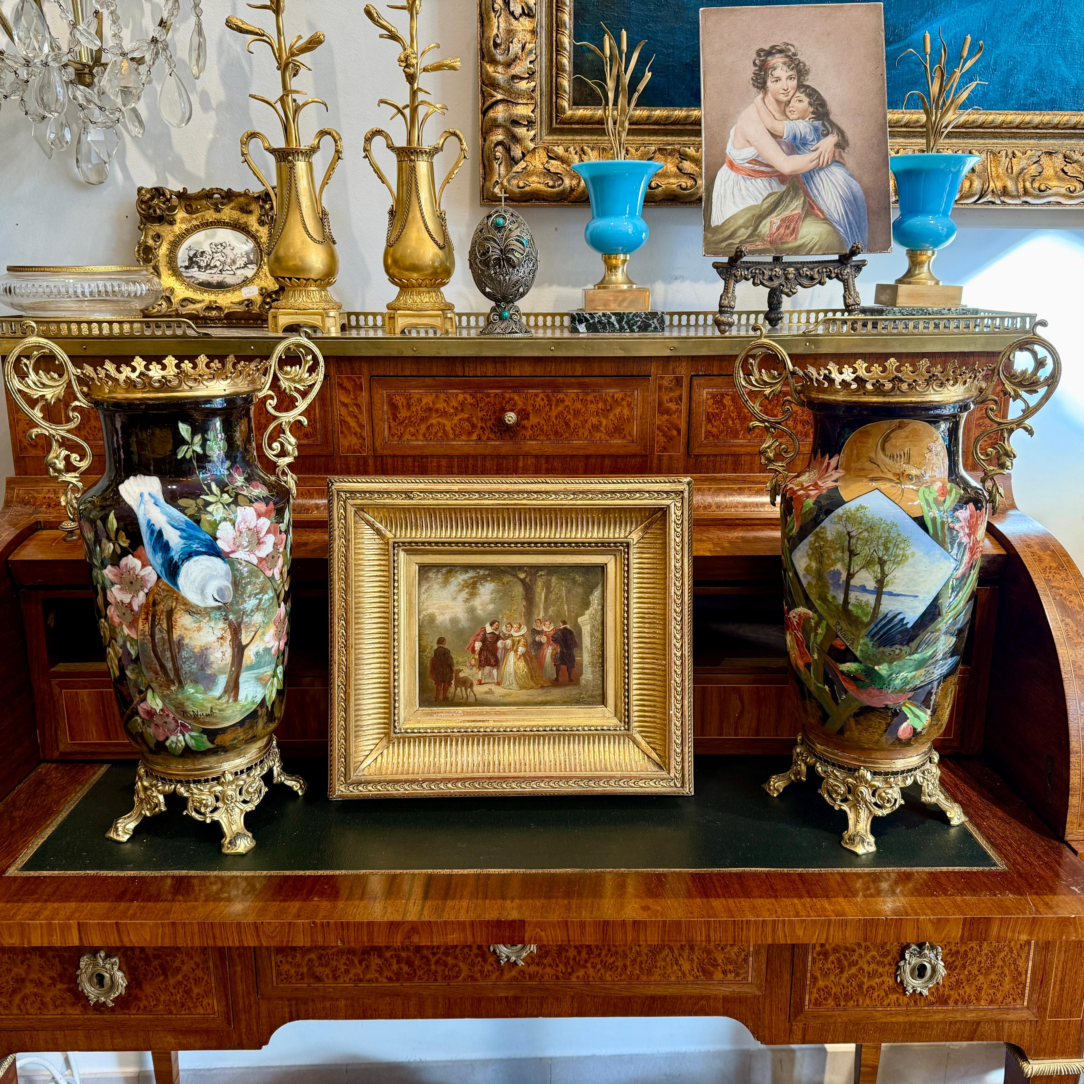 A pair of French hand-painted ceramic vases, each signed R. Nault, dating from the late 19th century. These vases feature hand-painted enamel scenes depicting elegant birds, blossoming flora, and serene natural landscapes. The delicate brushwork and