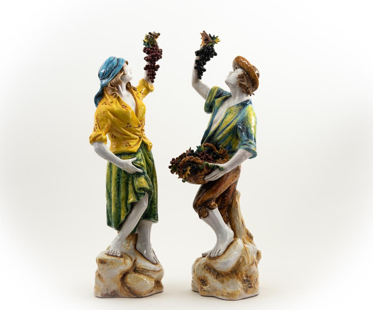 Offered is a pair of hand painted Italian pottery figures in vibrant colors that are celebrating the wine harvest with bare feet and grapes in hand. These are larger than they appear in the pictures and are sure to make you smile when you enter the
