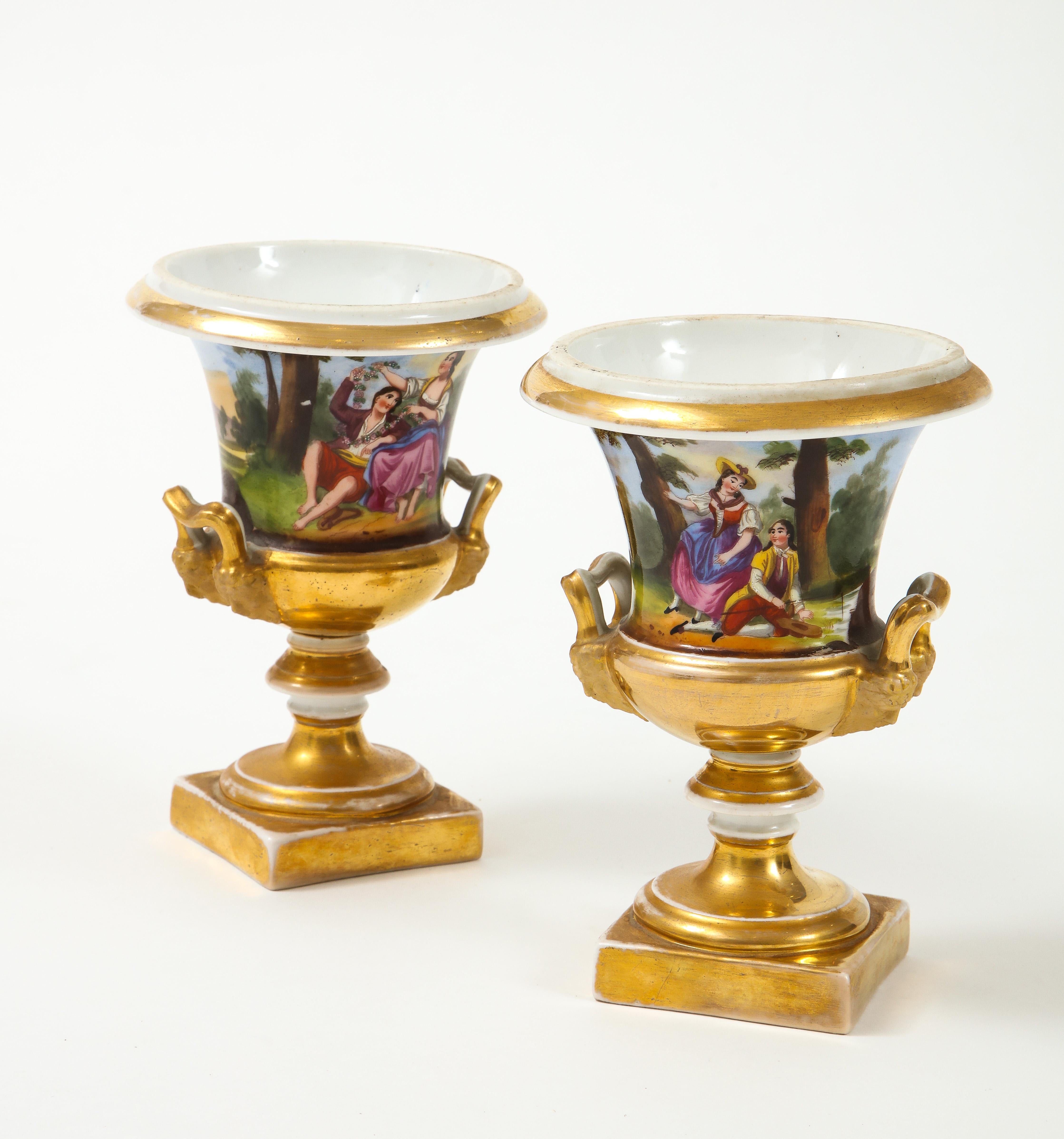 Pair of Austrian porcelain cache pots depicting a romantic couple and country scene, with hand applied 24 gilt scents. Perfectly sized for mantles or bookcases.