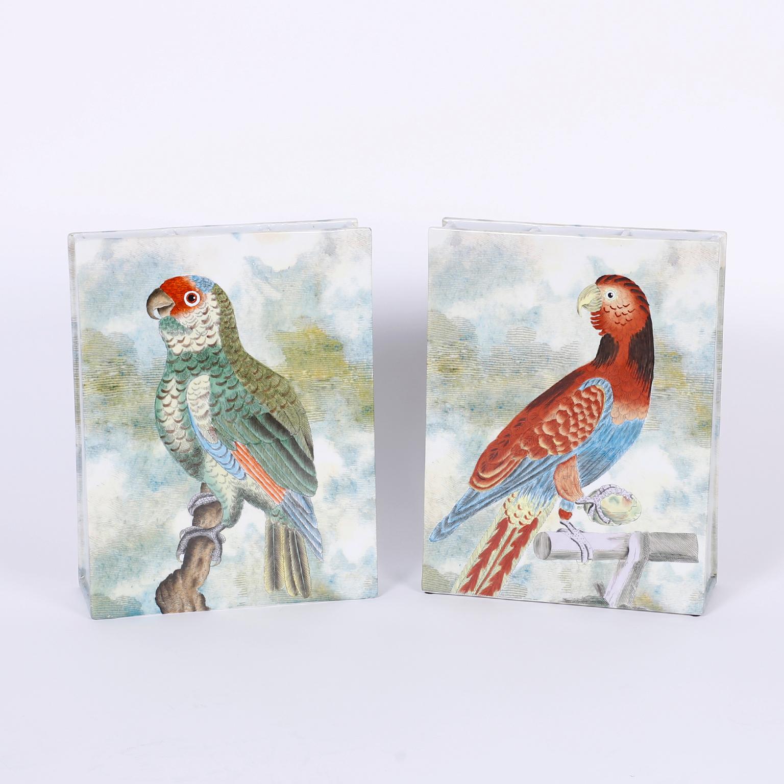 Unusual rectangular porcelain flower vases decorated on both sides with hand painted tropical colored varying parrot species. The opening on the tops is divided into three sections for optimal arrangement opportunities. Signed John Derian on the