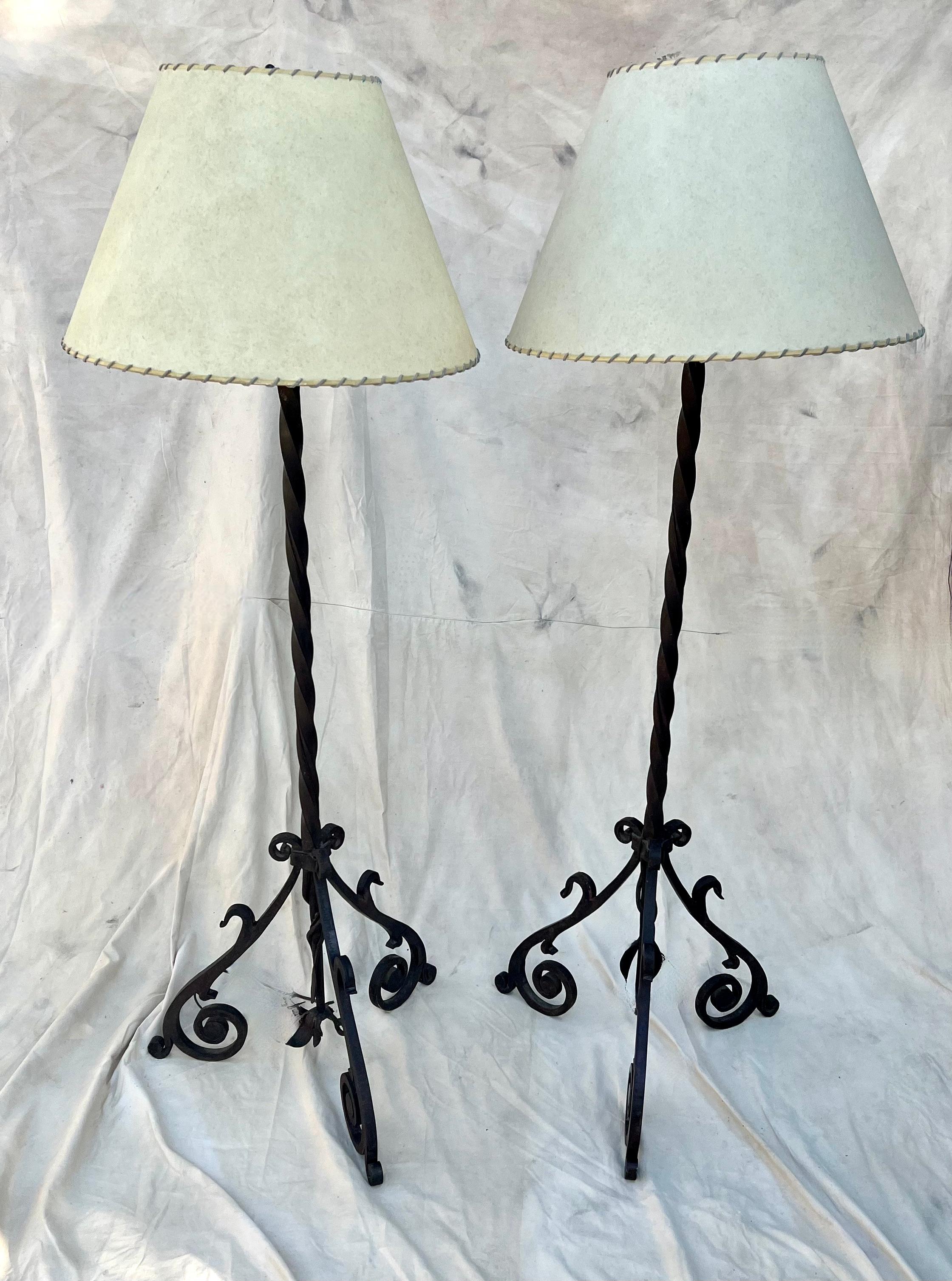 Pair of Hand Wrought Iron floor lamps.  The pair are spectacular, heavy and come with their own parchment shades...  The Core of 1