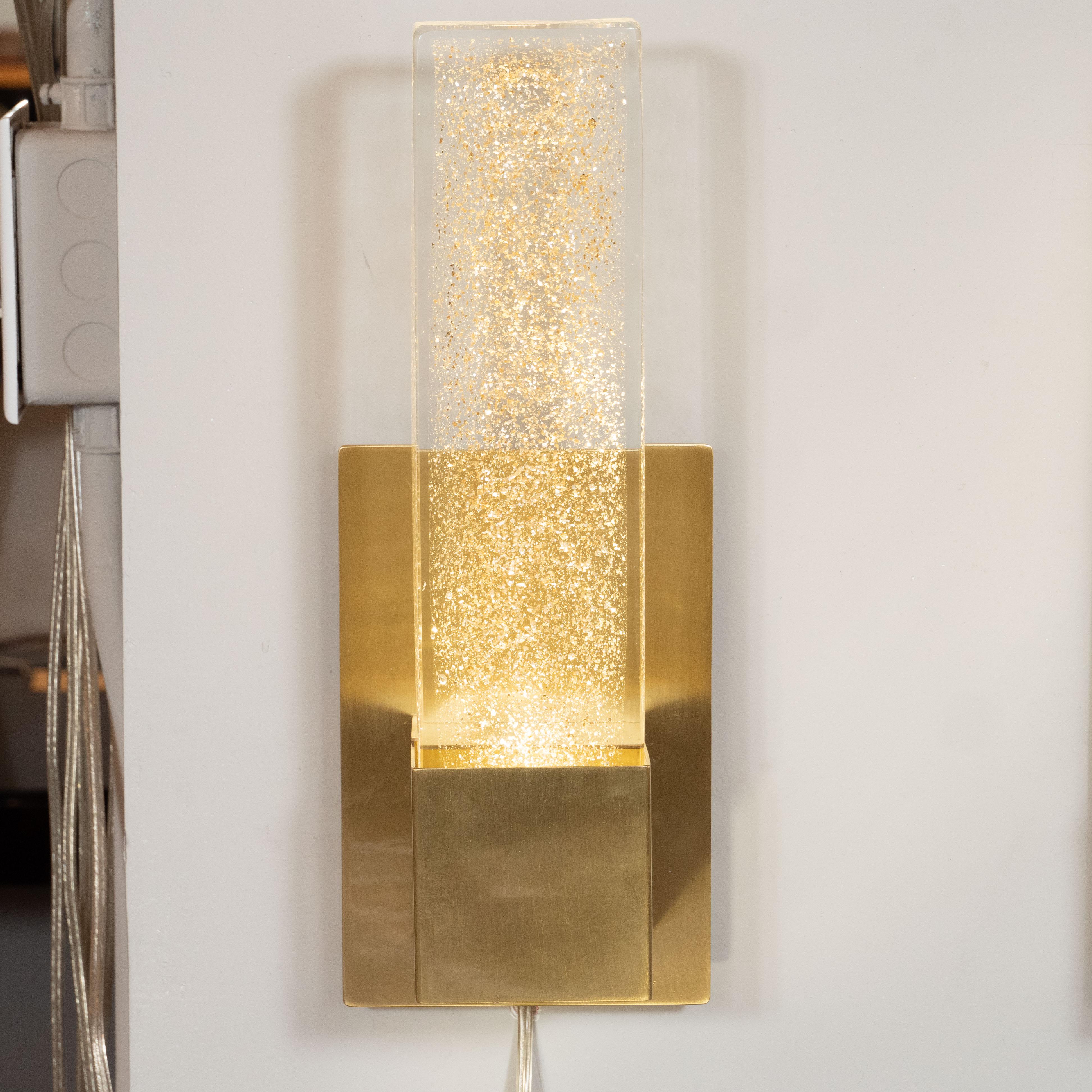 This stunning pair of modernist sconces were realized in Murano, Italy- the island off the coast of Venice renowned for centuries for its superlative glass production. They feature volumetric rectangular bodies imbued with an abundance of 24-karat