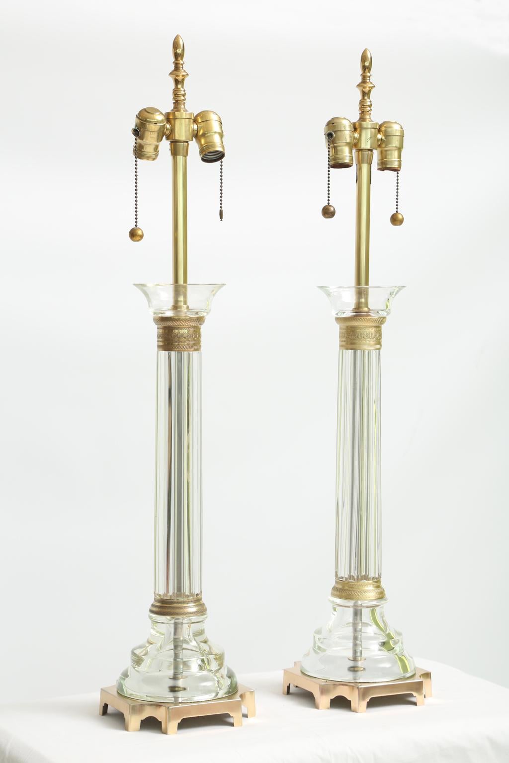 Large pair of clear Murano glass column-form table lamps, by Seguso for Marbro. Hand blown and formed elements include the ribbed central columns mounted with hand engraved brass ring accents, raised on square brass bases.

Stock ID: D2174.
