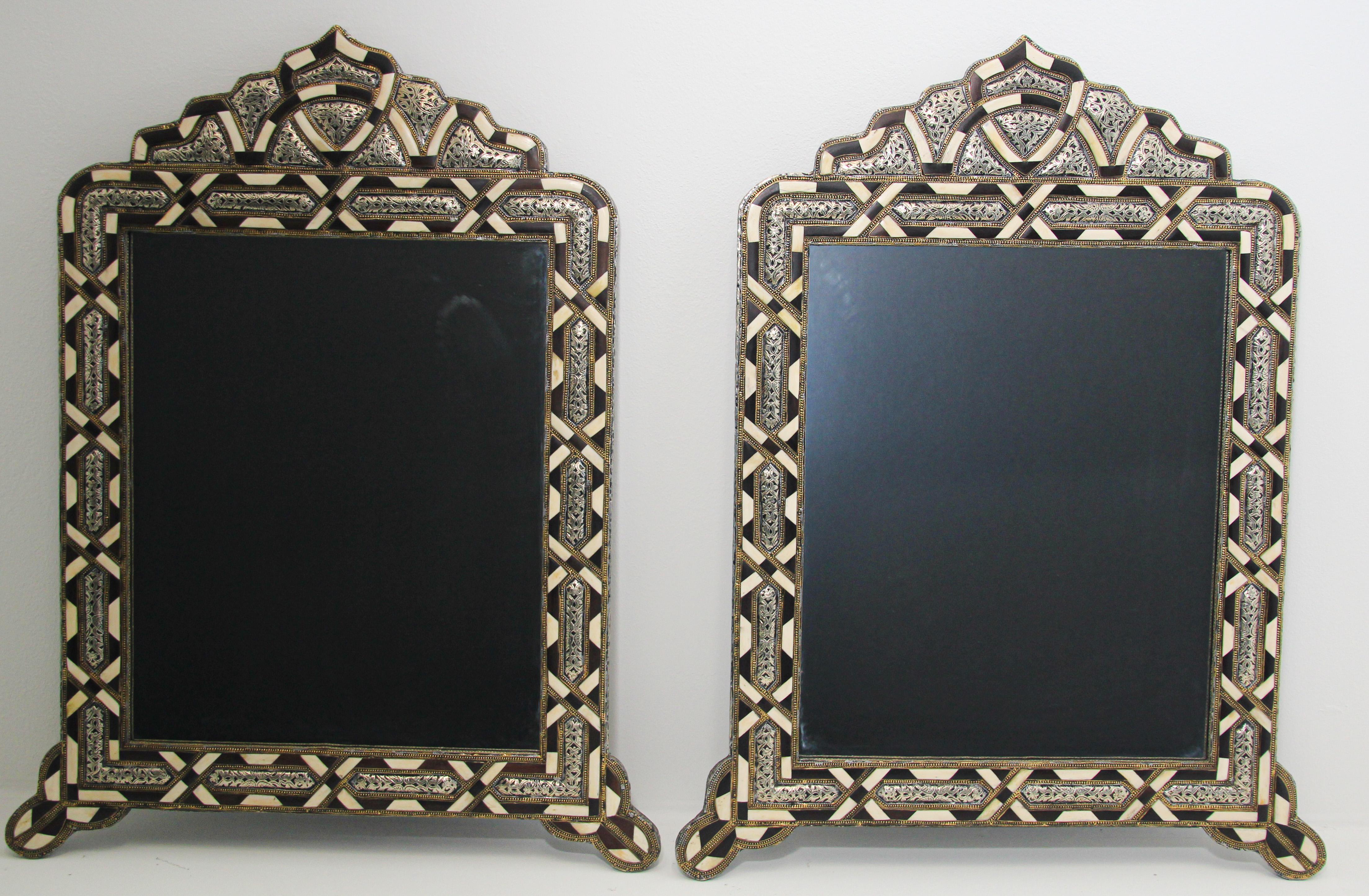 Handcrafted bone and silver arched Moroccan Moorish mirrors.
Elegant rectangular shape wall Moroccan mirror decorated with silvered metal delicately engraved and wood and bone overlay.
Pair of Moroccan mirrors inlaid with camel bone and brass