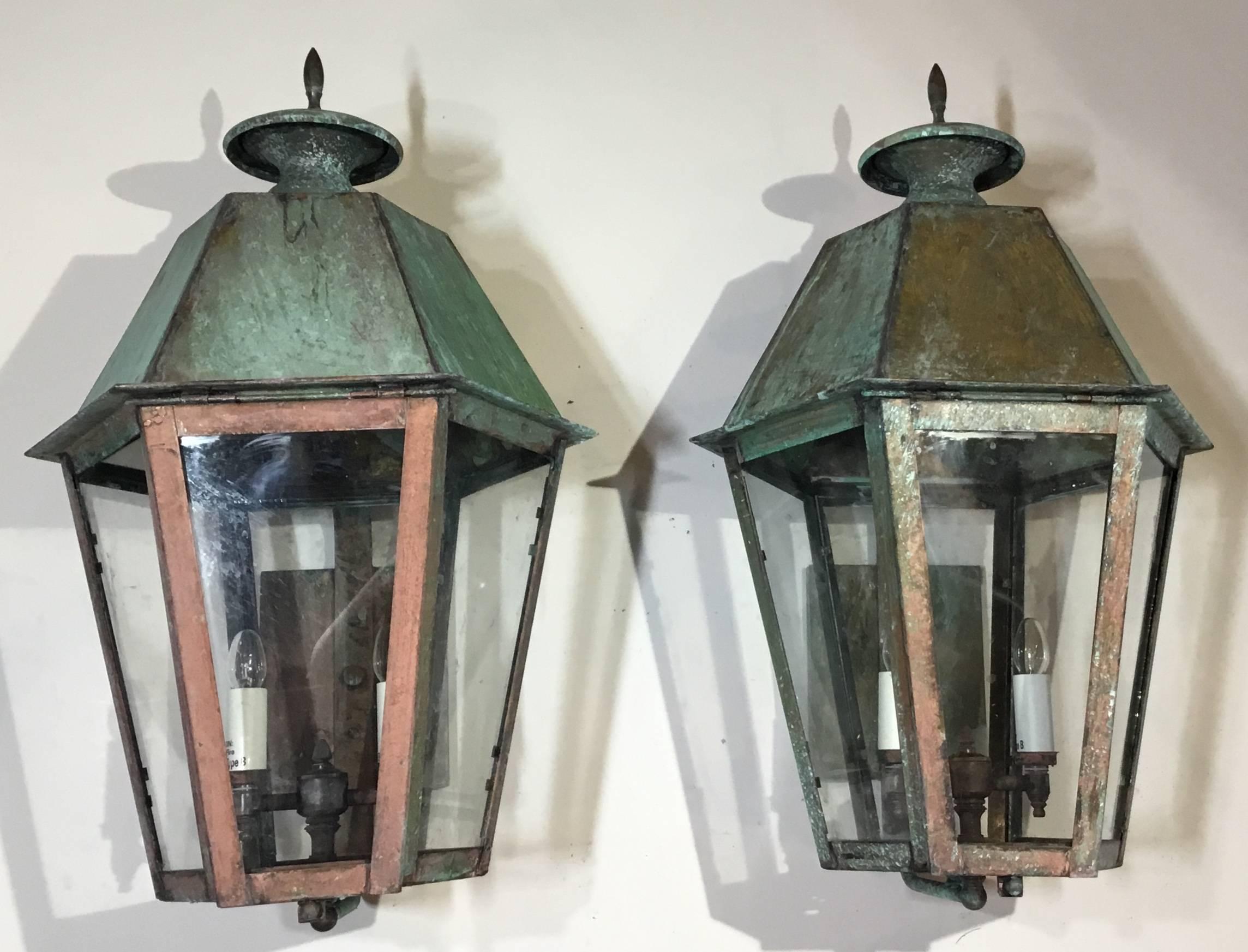 Decorative pair of wall lanterns Made of solid brass with three 40/watt lights each, suitable for wet locations, up to US code, UL approved.