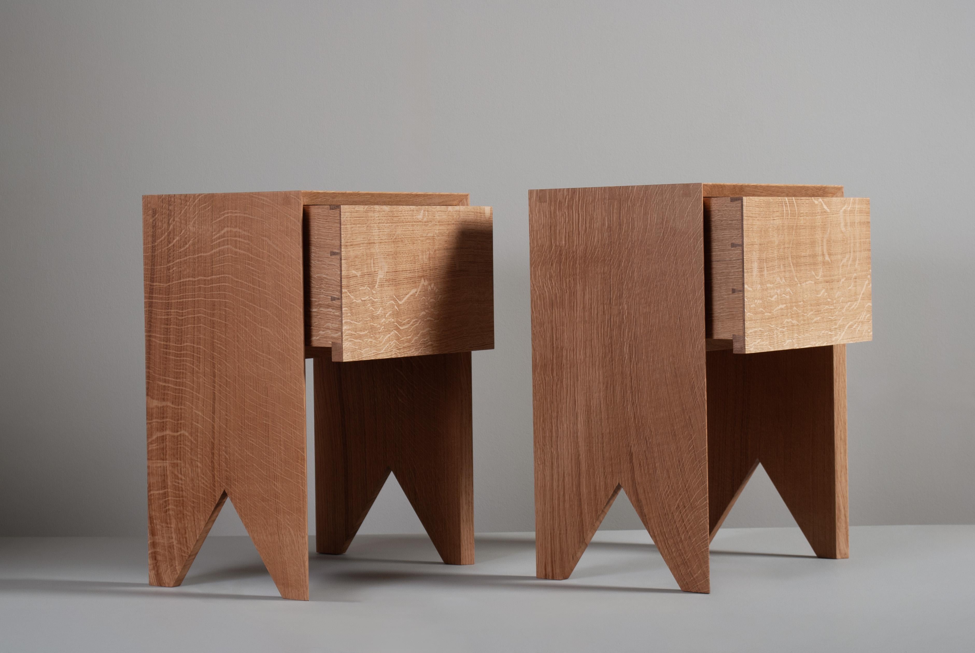 A pair of sleek contemporary hand-crafted English quartersawn Oak end tables with storage drawer. 
Designed with precise minimalism in mind - whilst highlighting the handmade construction details with exposed mitred key dovetail jointing. The strict