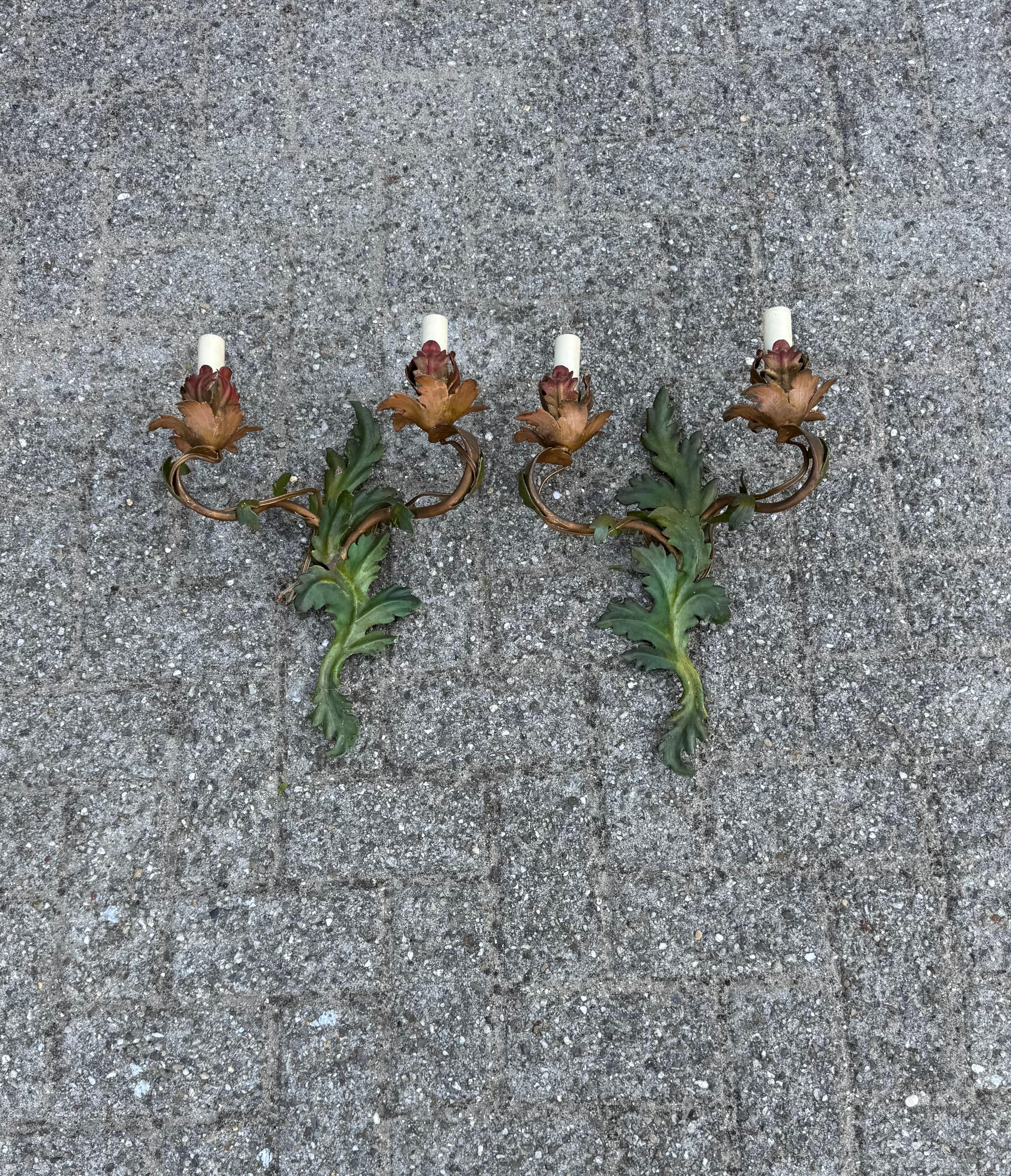 Stylish and highly decorative pair of work of lighting art sconces.

If you're looking for a pair of charming, two-light wall sconces to grace a special space, these handcrafted fixtures could be just what you need. Made from hand-forged and painted