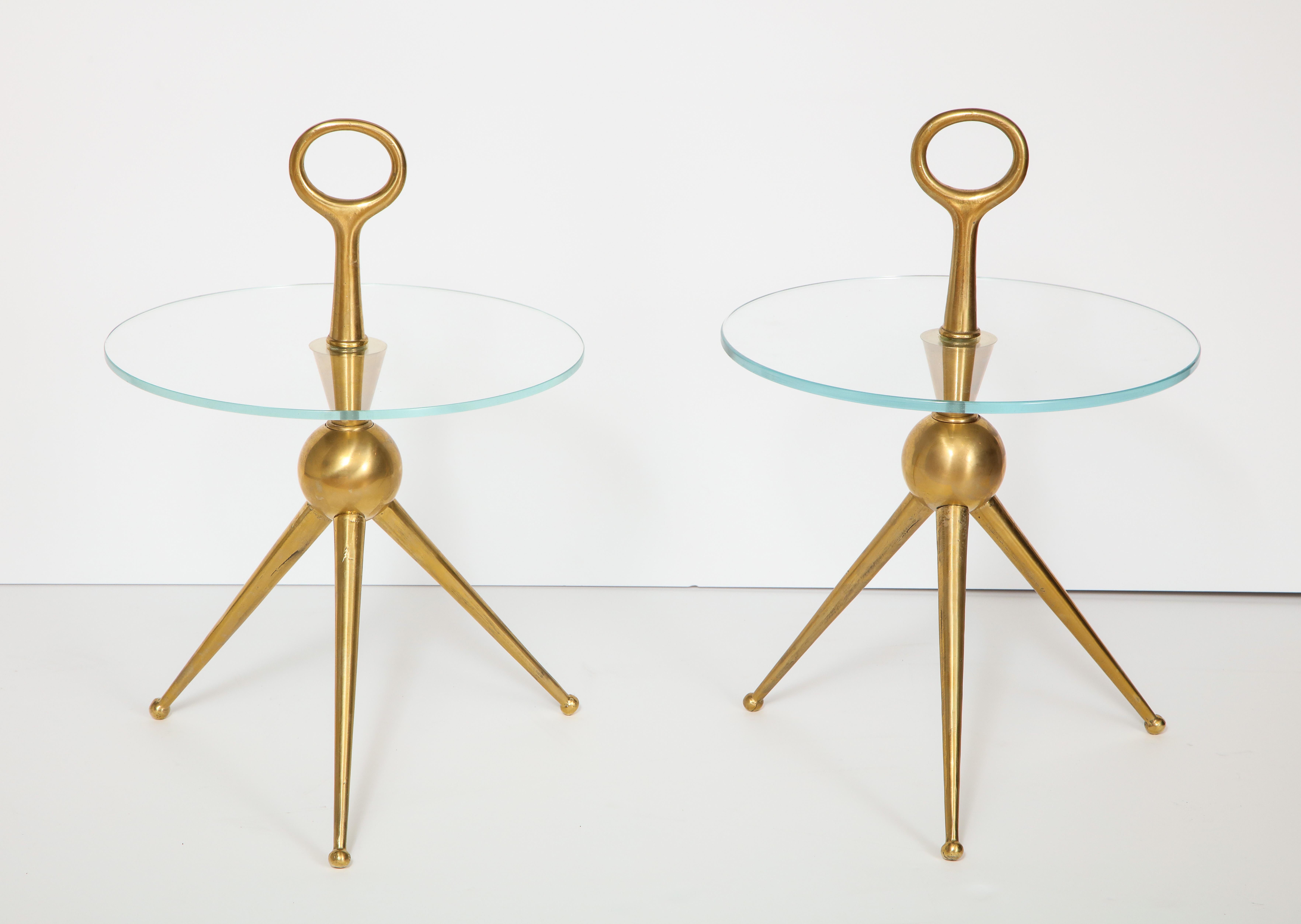 Pair of Italian bronze martini side tables with clear round glass tops. Tripod base and with eyehook handle. Handcrafted in Florence of solid bronze. A work of art. Overall height of table, including handle is 23
