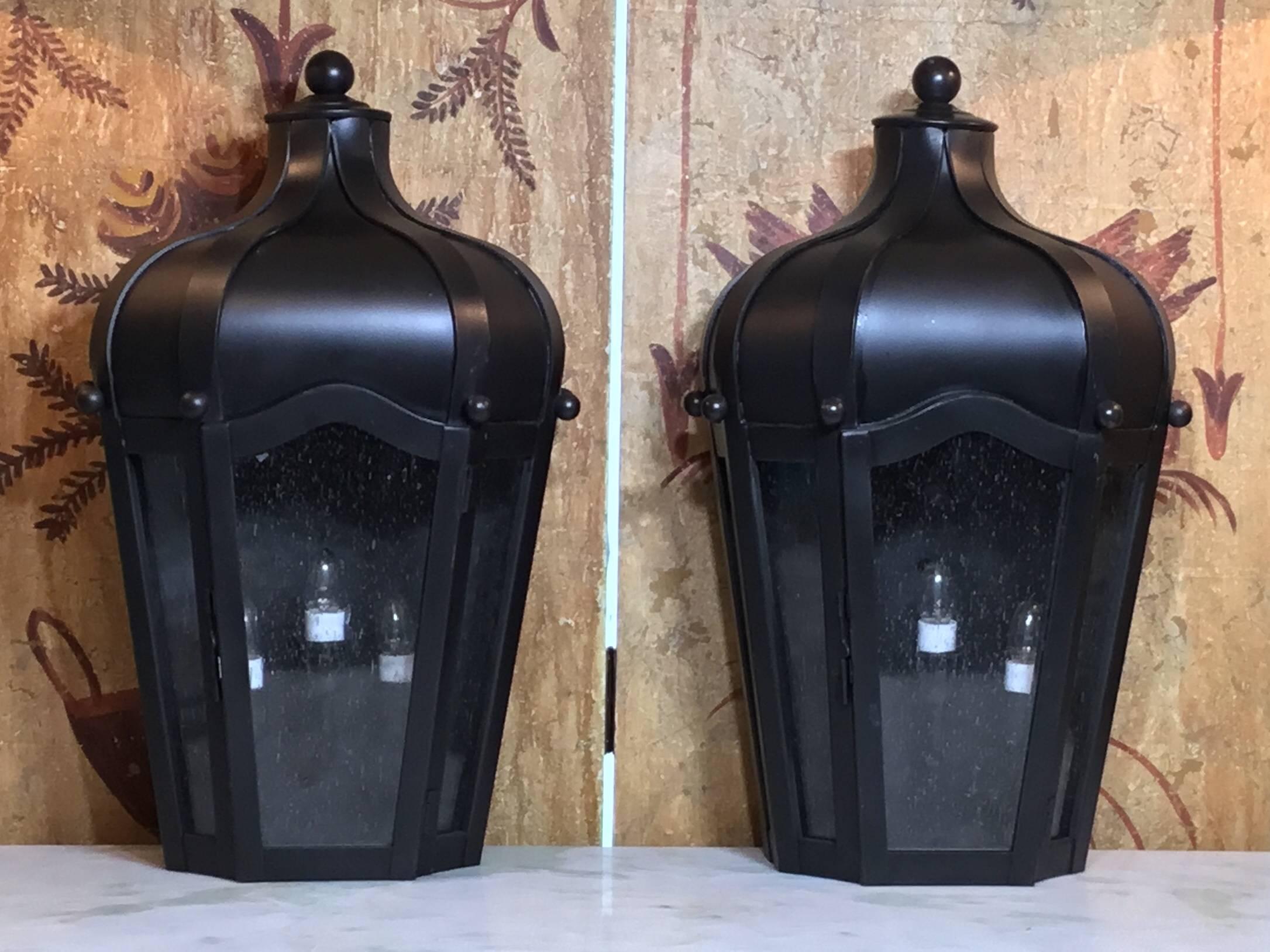 Pair of exceptional wall lanterns made of solid brass, seeded glass,
Electrified with three 40/watt lights each. Suitable for wet locations, UL approved, up to US code. Great decorative pair for indoor or outdoor.