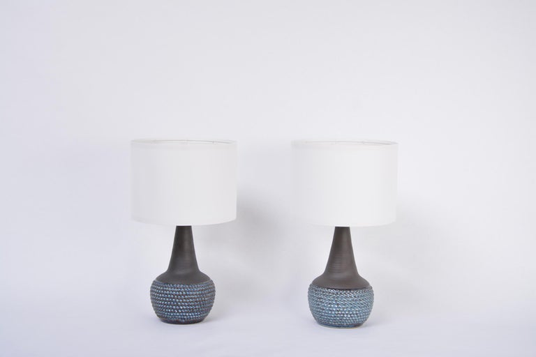 Pair of handmade blue Danish mid-century stoneware lamps by Soholm
Stunning table lamps handmade of stoneware with ceramic glazing in different tones of blue designed by Einar Johansen and produced by Danish company Soholm. 
Circular pattern to
